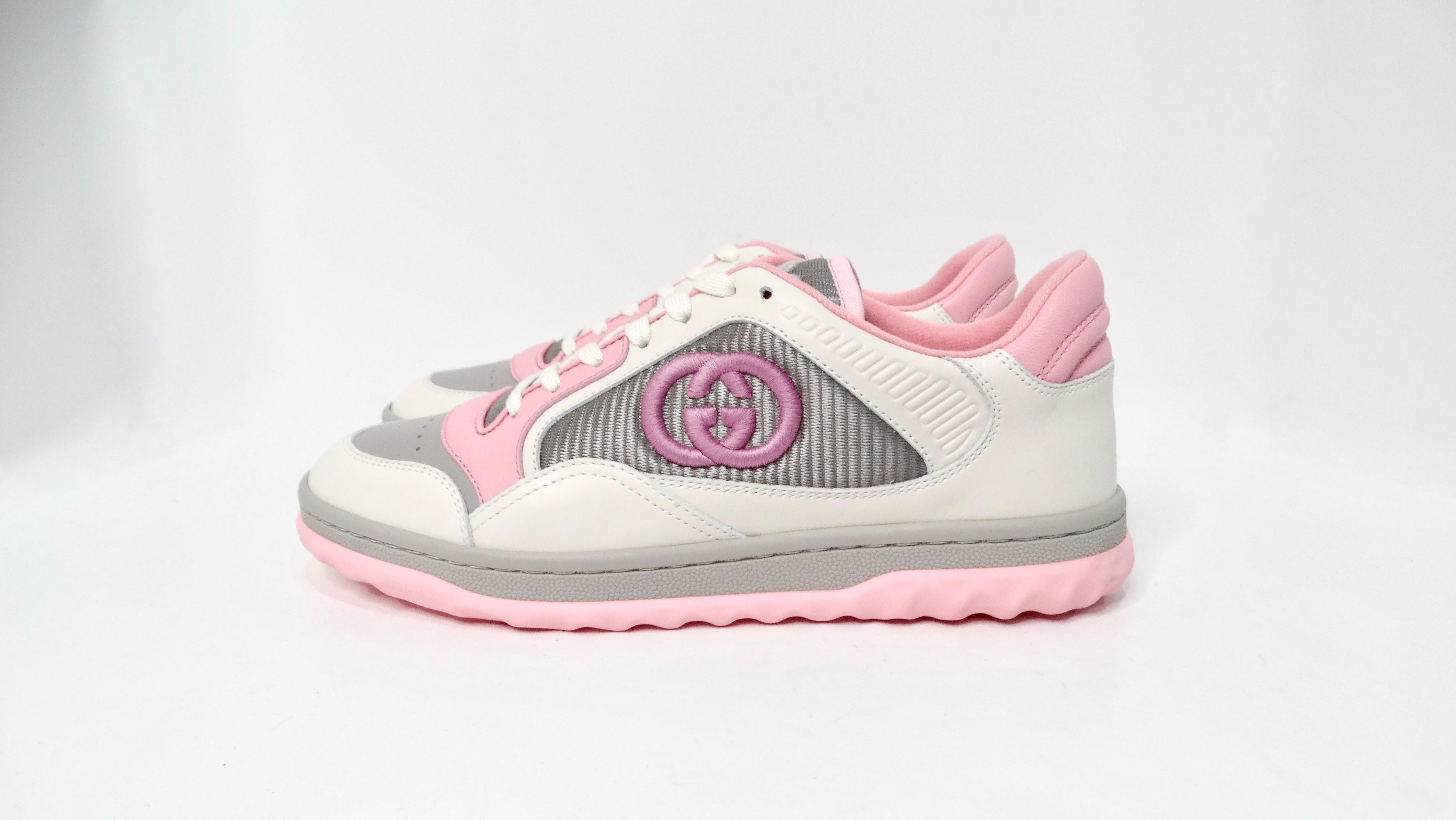 The Gucci Mac80 Pink & Grey Calfskin Leather Sneakers offer a sophisticated yet sporty appeal, making them a quintessential addition to any fashion-forward wardrobe. With a white base accentuated by soft pastel pink and grey detailing, these
