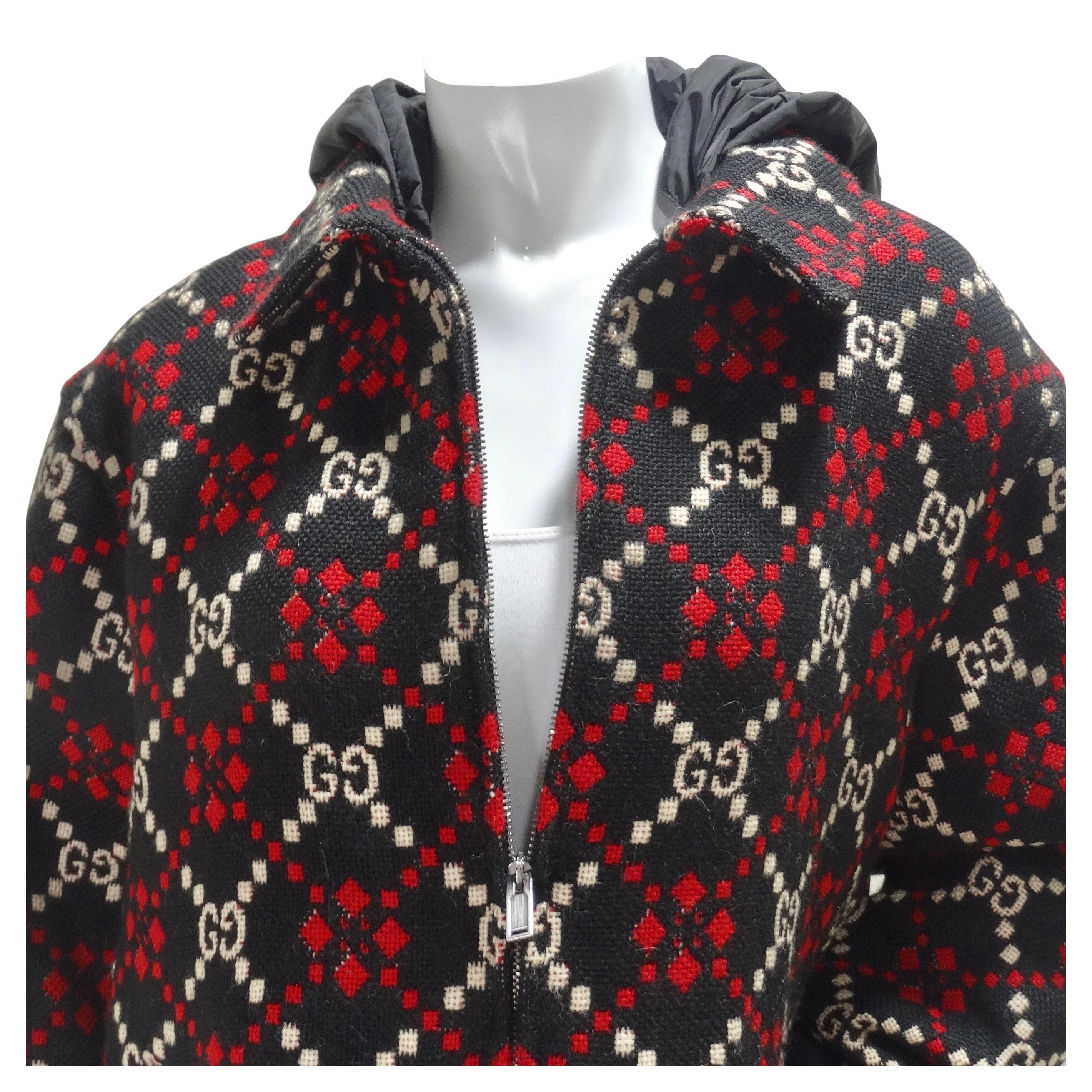 Amazing 100% wool Gucci jacket in Gucci's iconic GG monogram. Featuring a central zipper, side pockets, and ribbed cuffs at the sleeves completed by a nylon windbreaker style hood which creates such an eye catching contrast! The fabric of this