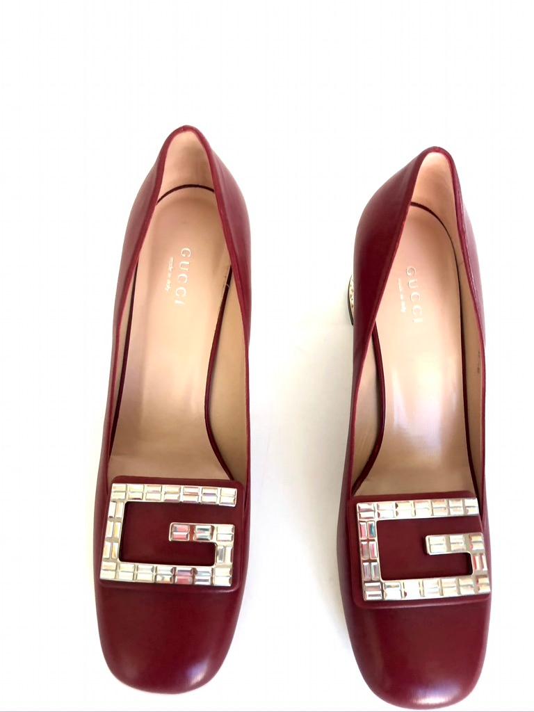 Gucci's red leather Madelyn pumps bring back the classic high-tongued shape in a contemporary rendition. This Italian-made shoe is constructed to a rounded-square toe topped with the house's glamorous crystal iteration of it's emblematic G, and rest