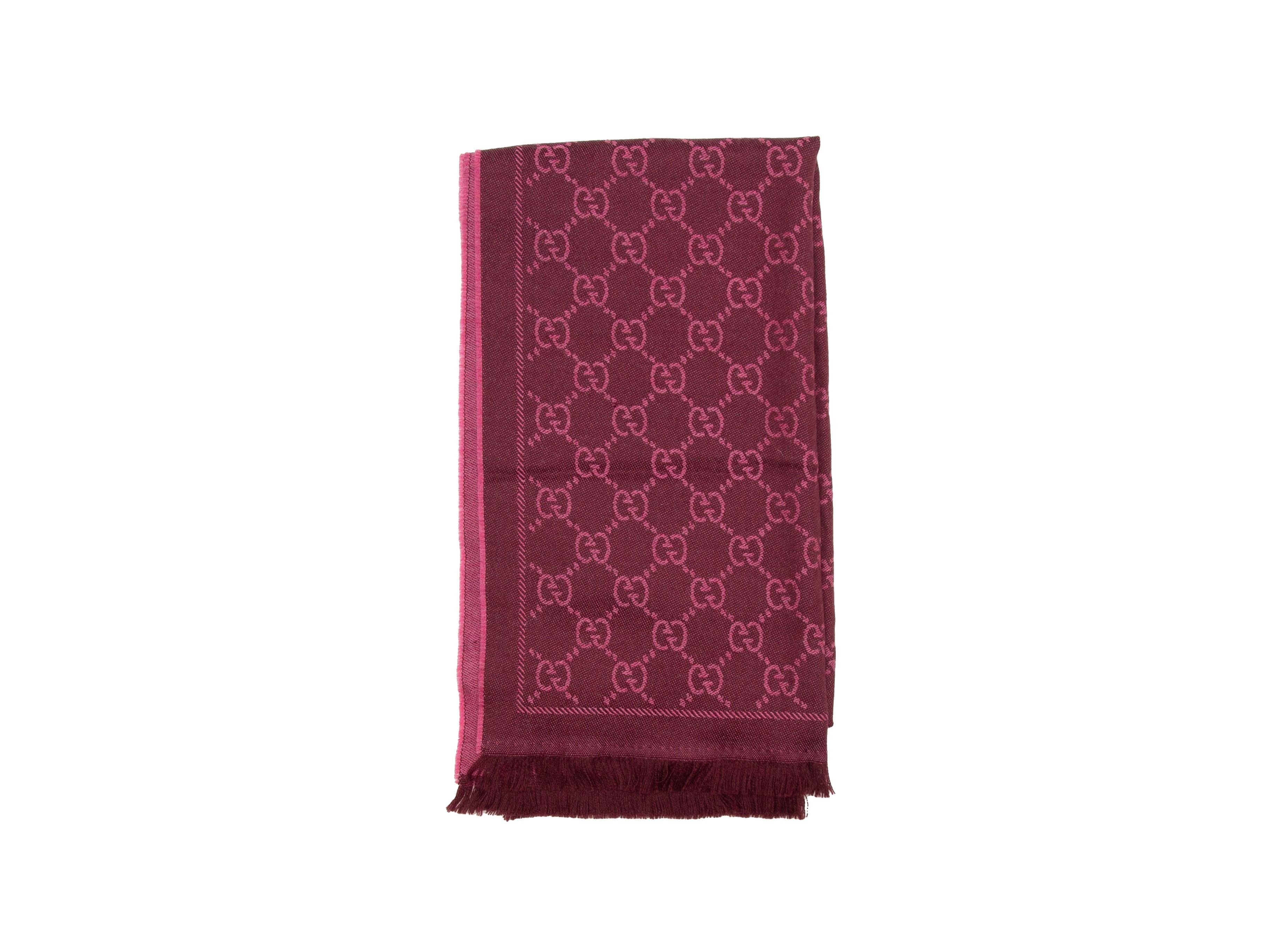 Product details: Magenta and burgundy monogram wool scarf by Gucci. Fringe trim at ends. 19.75