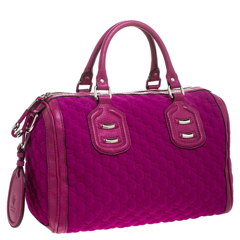This Gucci bag is ideal for elevating your daily looks. Crafted in magenta Guccissima neoprene, this stylish bag features dual-rolled leather handles, leather trims, and silver-tone hardware accents. Its zip closure opens to a nylon-lined interior