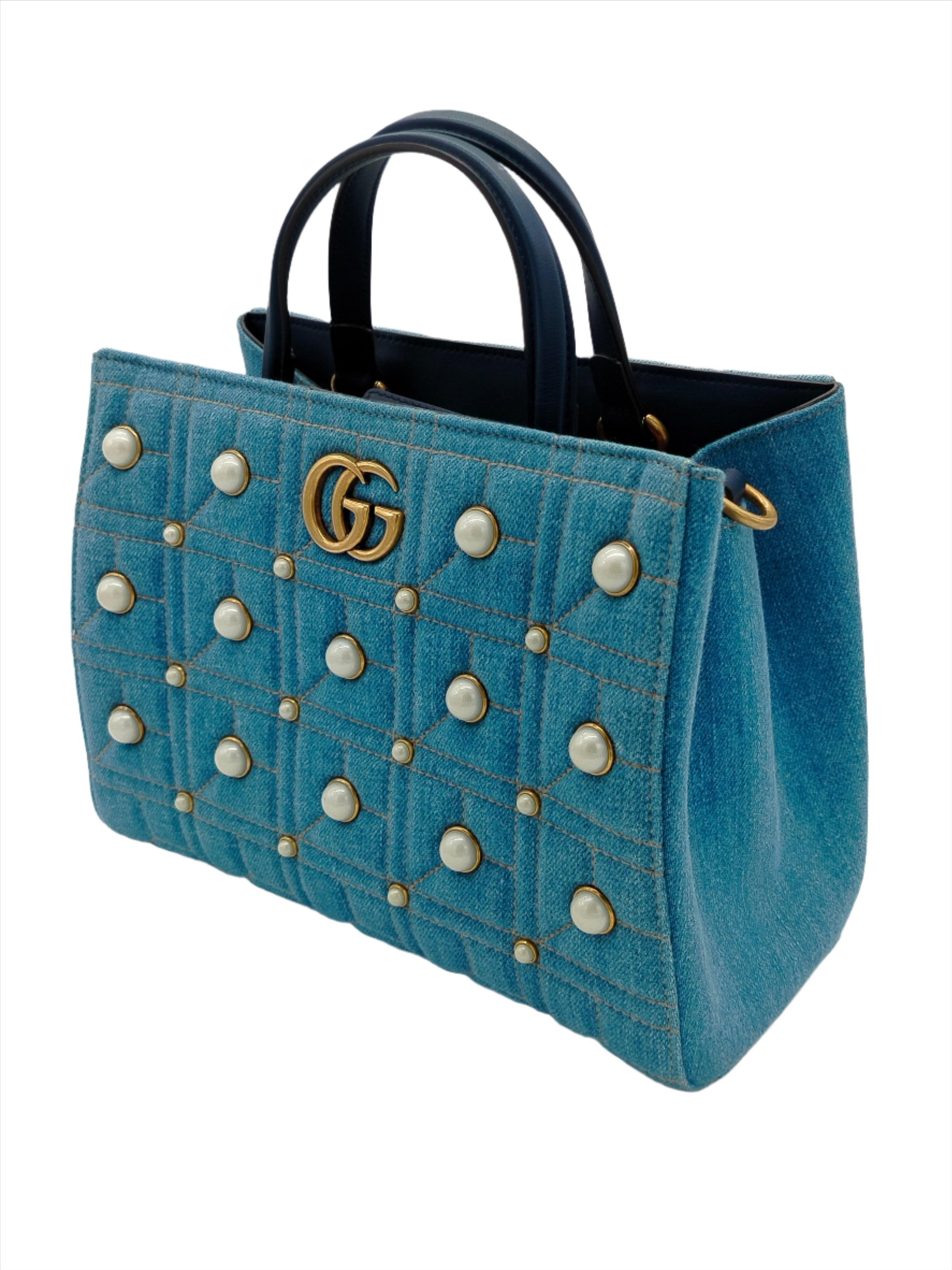 Full of style and practical design, this Gucci Marmont tote bag is a precious fashion accessory. It is made from quilted denim with pearls stitched on the face of the bag.
Inclusion: dust bag.

Material: Leather