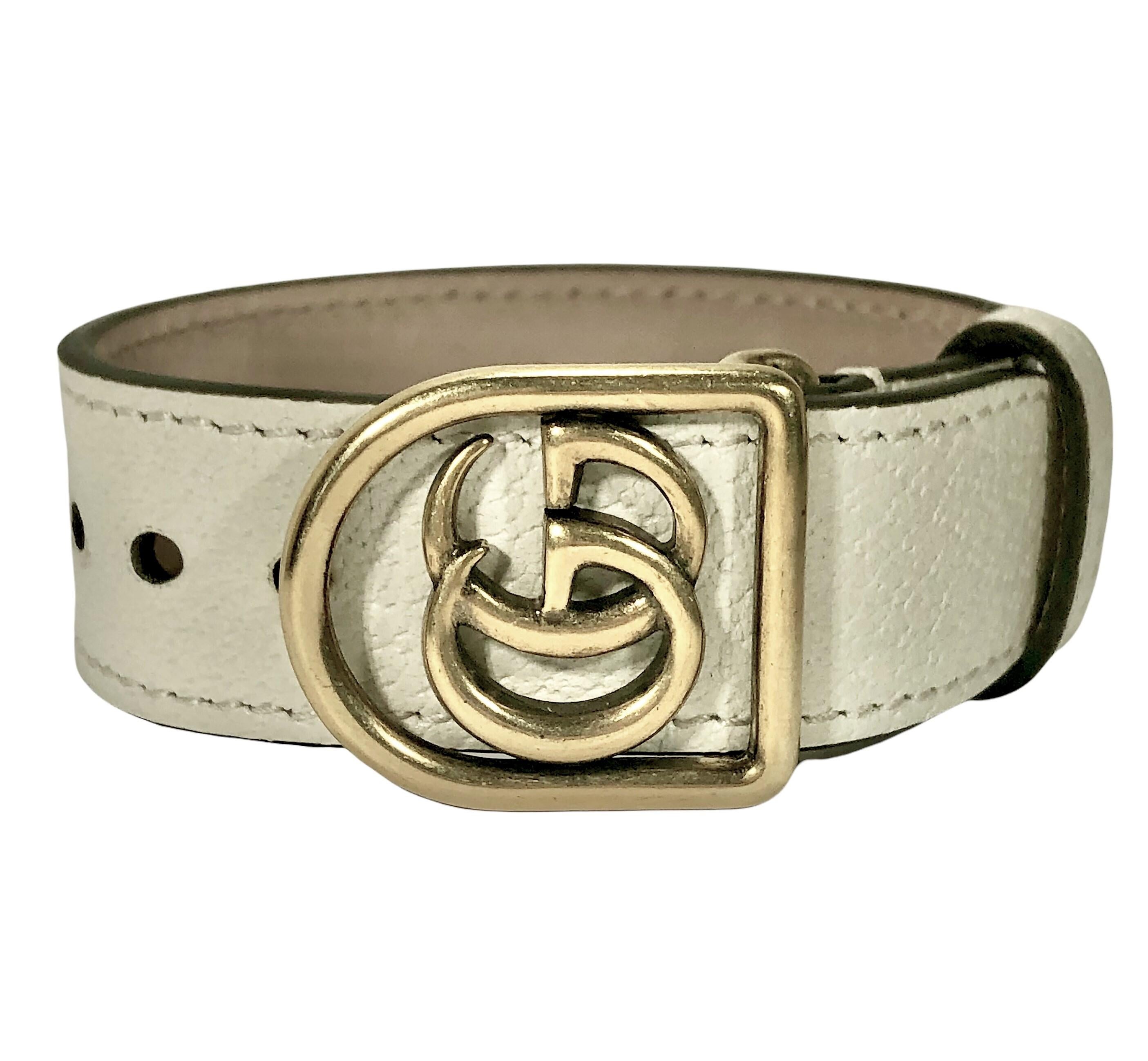 This lovely Italian Gucci Marmont gold tone Double G bracelet has an off white  leather strap.  Total length is 11 1/8 inch and the width is a very substantial 1 1/8 inch. Embossed GUCCI-MADE IN ITALY ON THE INSIDE. This bracelet fits a medium to