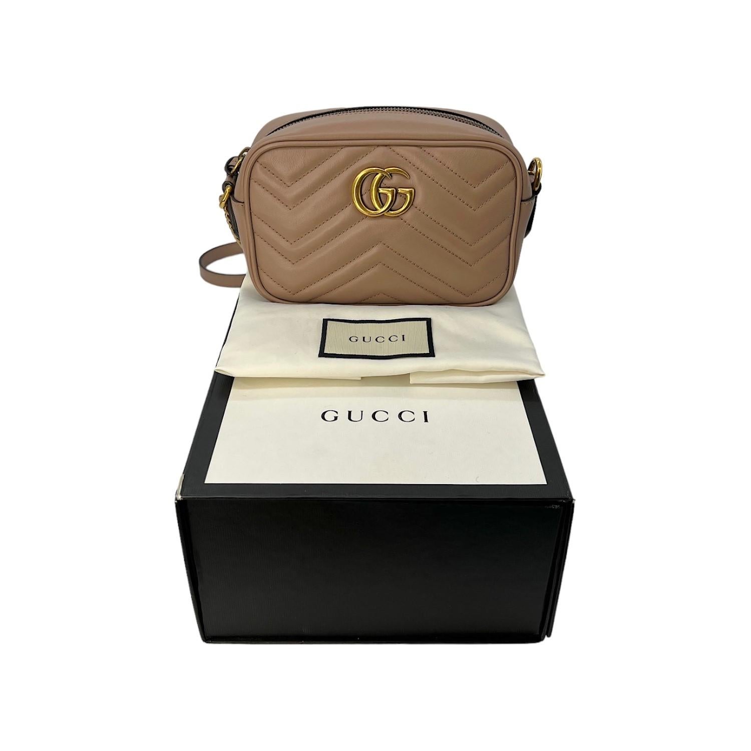 This Gucci Marmont Matelassé Mini Shoulder Bag was made in Italy and it is finely crafted of Gucci GG Matelassé leather with gold-tone hardware features. It has a flat leather shoulder strap. It has a zipper closure that opens up to a spacious suede