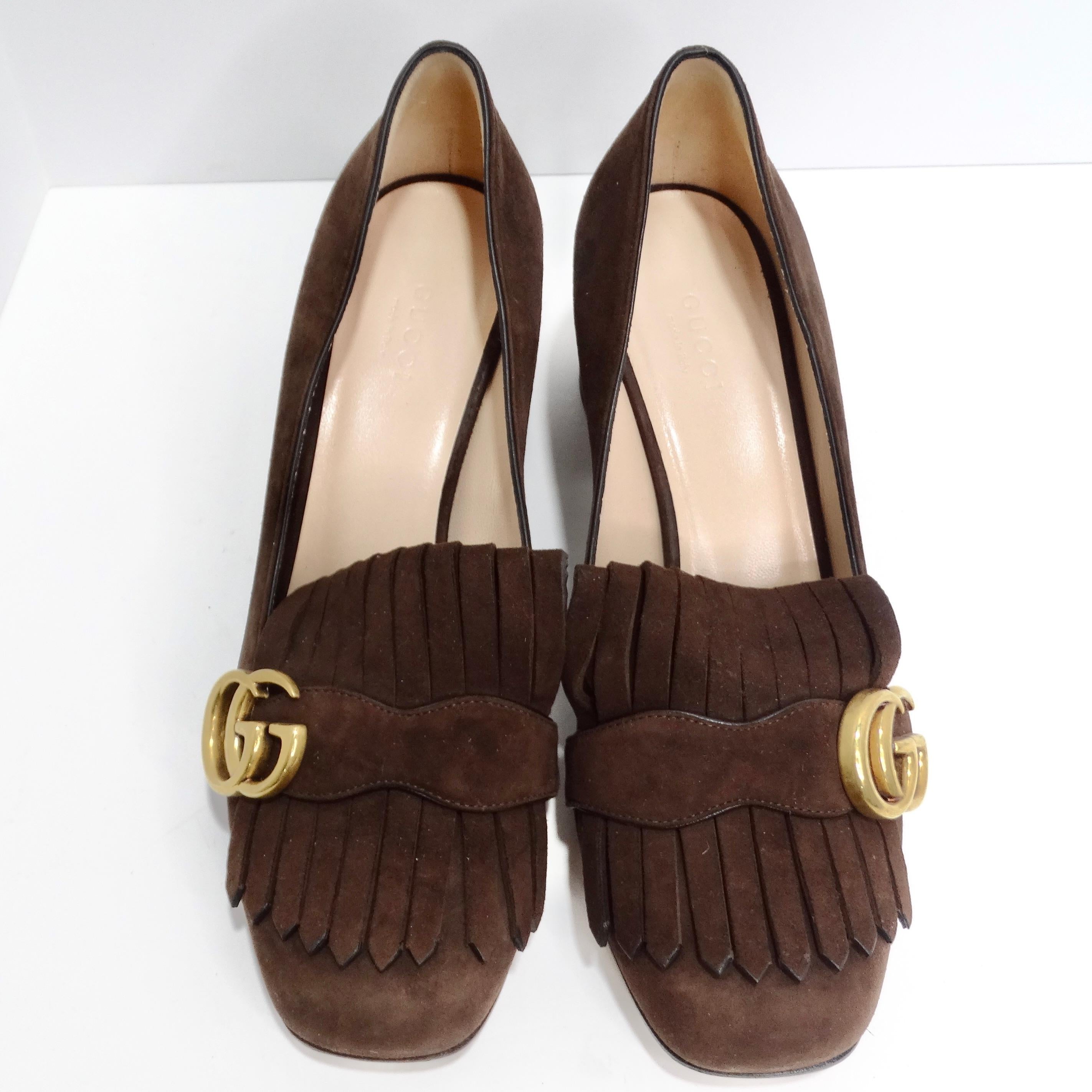 Introducing the Gucci Marmont Mid-Heel Fringe Pumps in Brown Suede, a perfect fusion of classic Gucci sophistication and timeless elegance that will elevate your footwear game to new heights. These mid-heel pumps beautifully blend classic Gucci