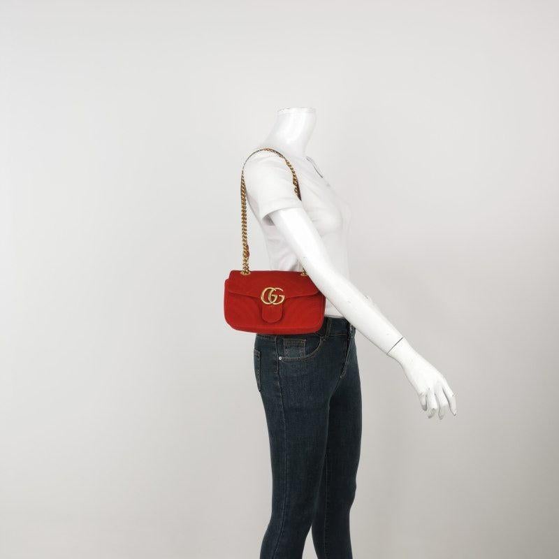 Gucci Marmont Mini Flap Red Velvet Handbag
  These are professional photos of the actual bag offered by Luxbags.
  The Gucci Marmont Mini Flap Crossbody Bag is a timeless and adaptable accessory designed by the renowned brand Gucci. Its signature