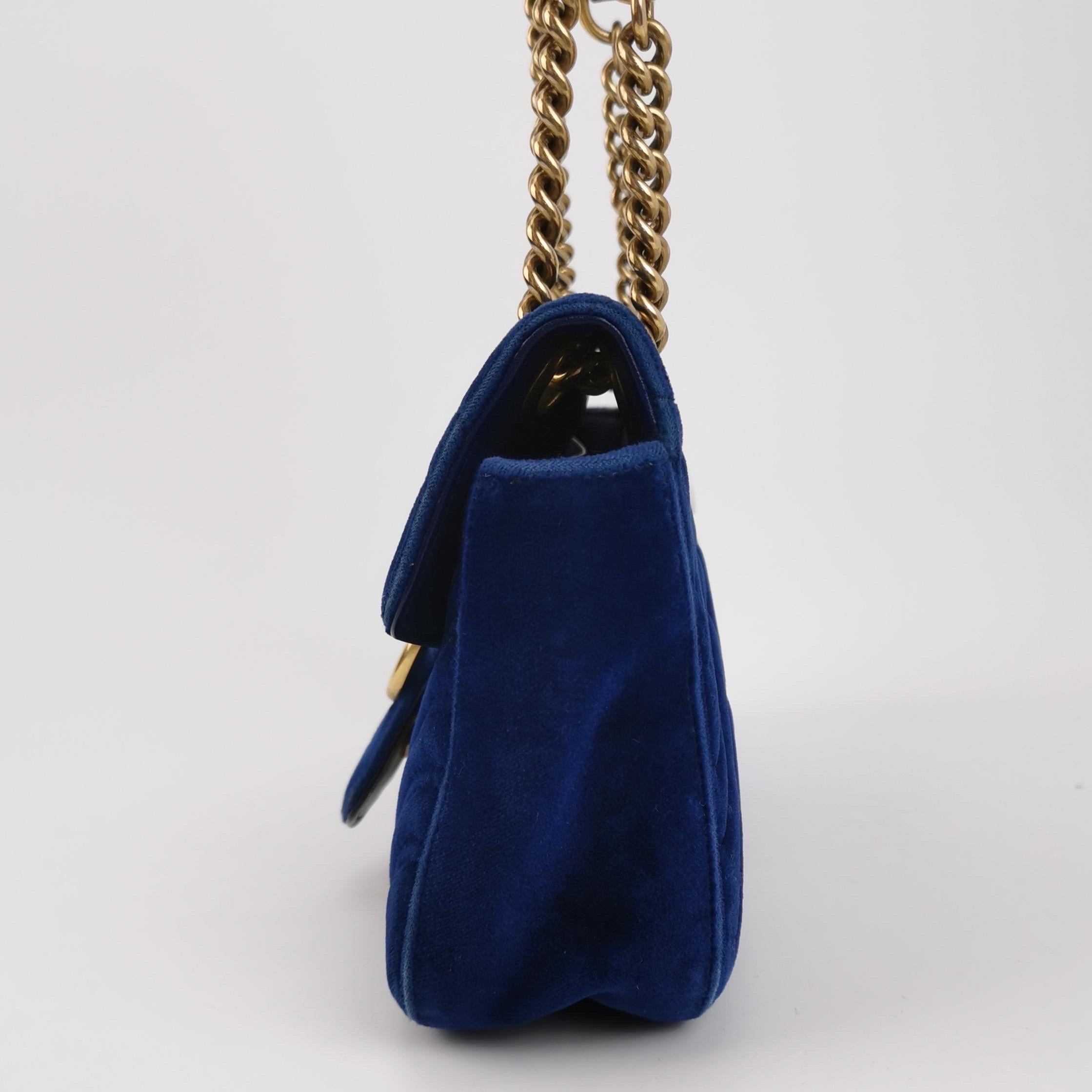Gucci Marmont Small Flap Turquoise Navy Velvet Handbag
 These are professional photos of the actual bag.
 The Gucci Marmont Flap Velvet Crossbody Bag is a timeless and adaptable accessory designed by the renowned brand Gucci. Its signature V-shaped