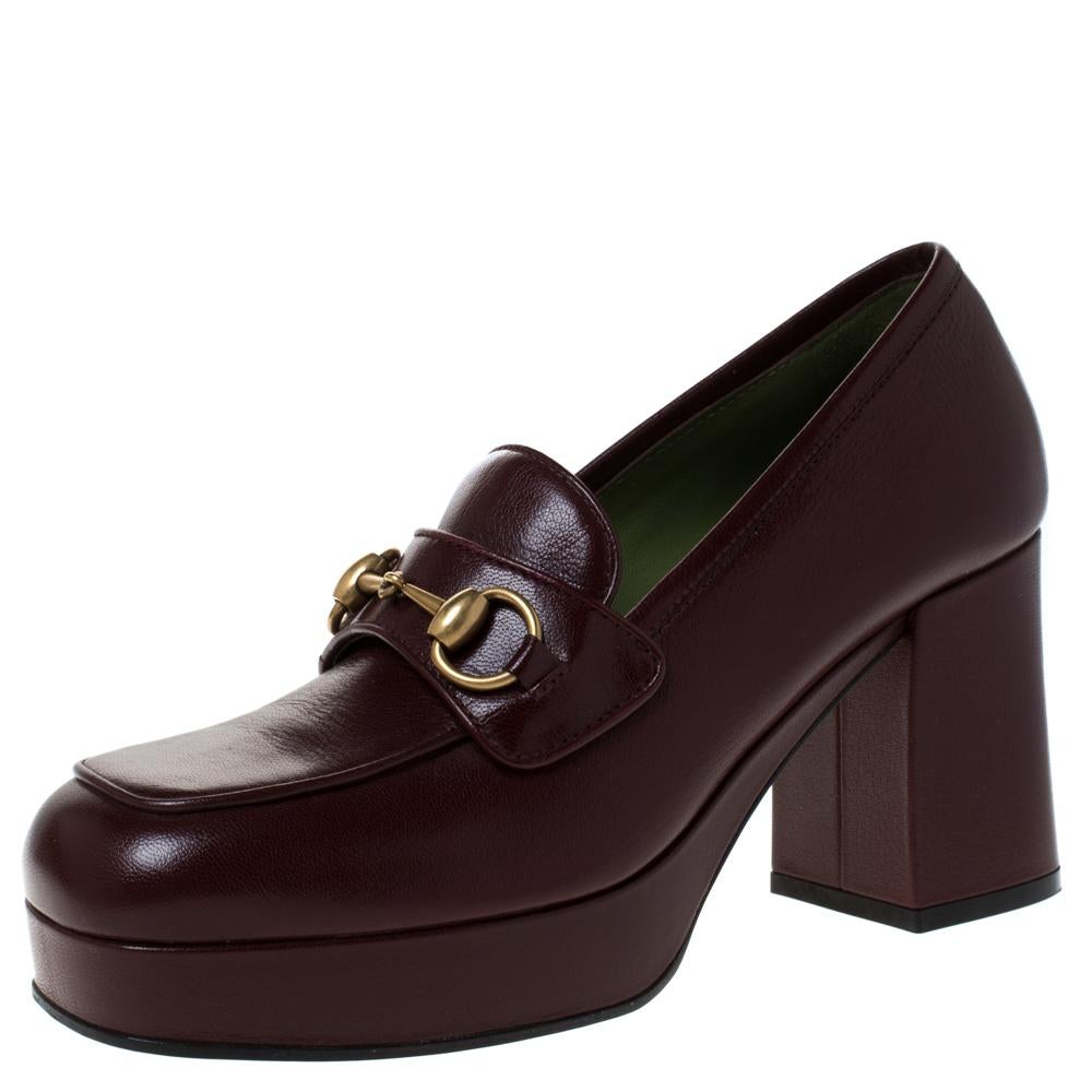 Featuring a chic, minimalist design, these loafer pumps from Gucci are easy to style. Maroon leather uppers showcase the signature Gucci Horsebit in gold-tone. High block heels, platforms and square toes form a distinctive outline. The simple design