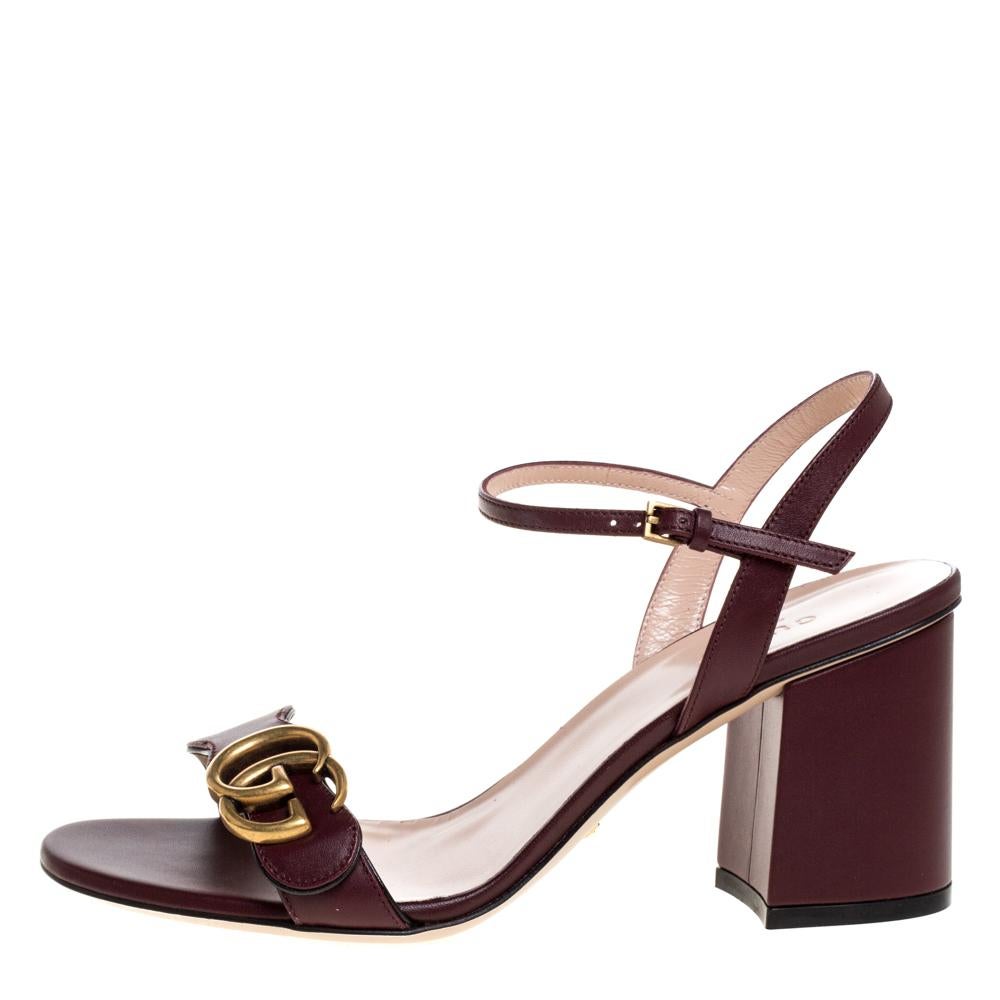 Exuding beauty in true luxury style are these maroon sandals from the house of Gucci! They've been crafted from leather and designed with buckle ankle straps, block heels, and the signature GG on the wavy upper straps.

Includes:Original Dustbag,