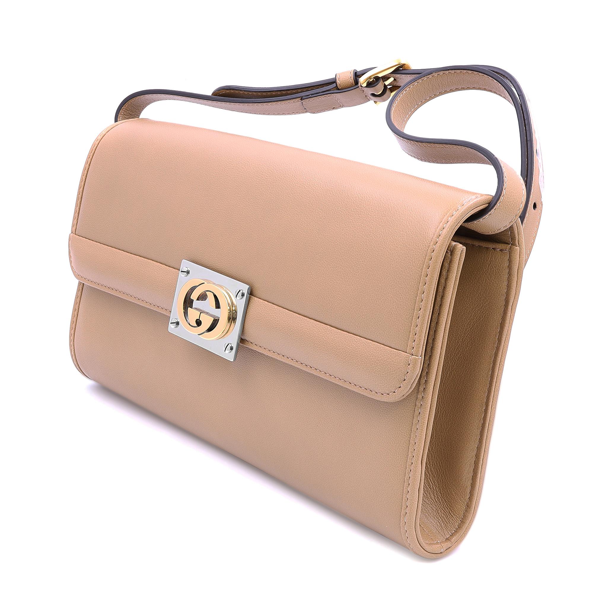 Gucci Matisse beige leather clutch/shoulder bag. It features a polished multicolor interlocking Gucci GG logo hardware on the front with a removable and adjustable beige leather shoulder strap with gold tone pin-buckle fastening. Turn lock closure