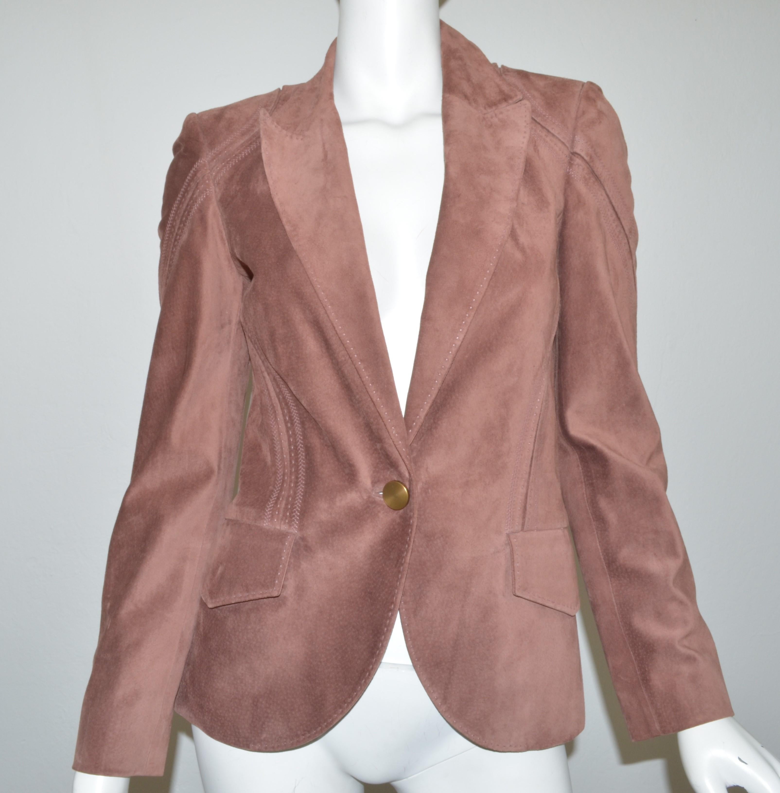 Gucci suede jacket featured in a mauve color with a single button closure and full lining. Jacket has two functional flap pockets. Size 40, Made in Italy.

Measurements:
Bust 33''
Sleeves 24''
Length 26''
Shoulder to shoulder 15''