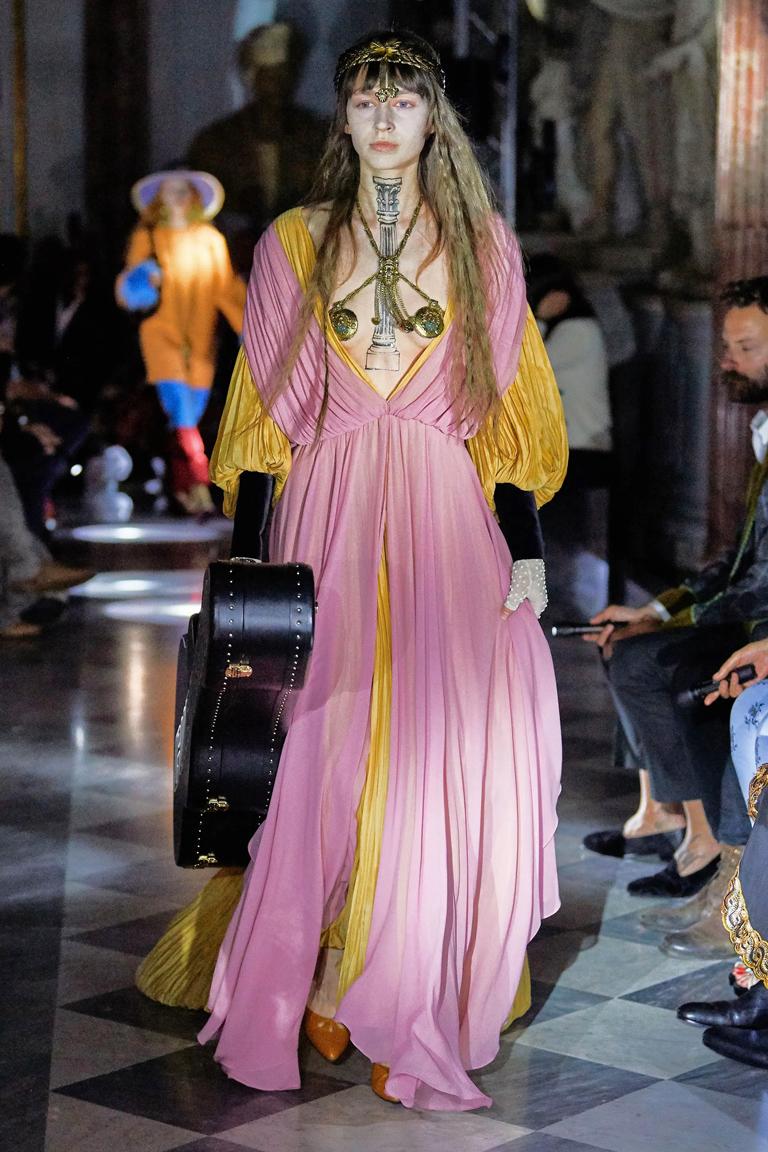 Stunning  medieval-inspired  Gucci  runway gown designed by Alessandro Michele.  Wonderful color combination of soft gold and plum pink silk finished with sumptuous black silk velvet cuffs with matching covered buttons.  Slight empire waist design