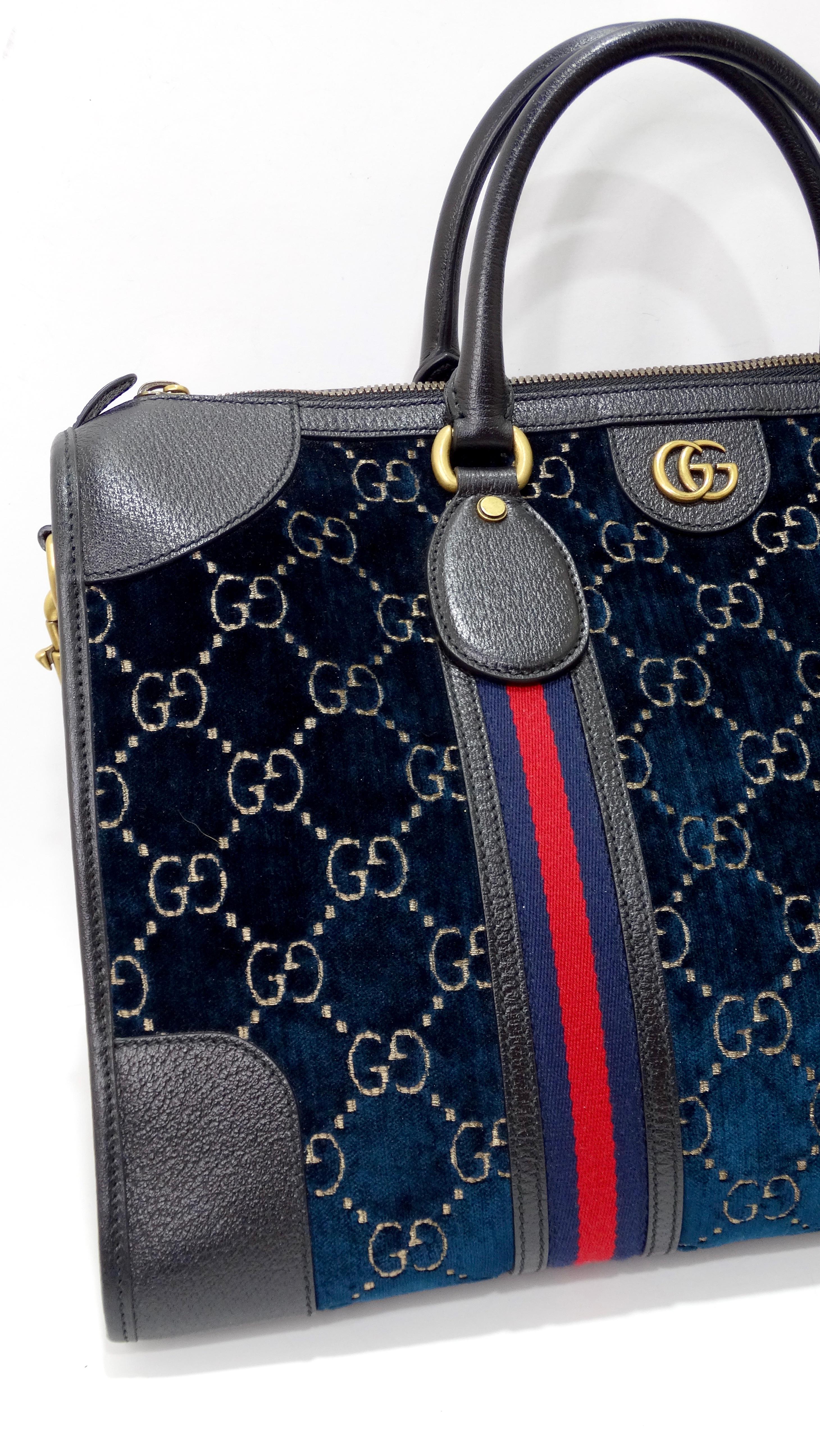 Go places in style with Gucci! Slot this dark blue medium GG velvet duffle bag into the overhead compartment and be on your way. Don't forget your passport! Make traveling feel luxurious no matter if you are in first class or coach. This Gucci