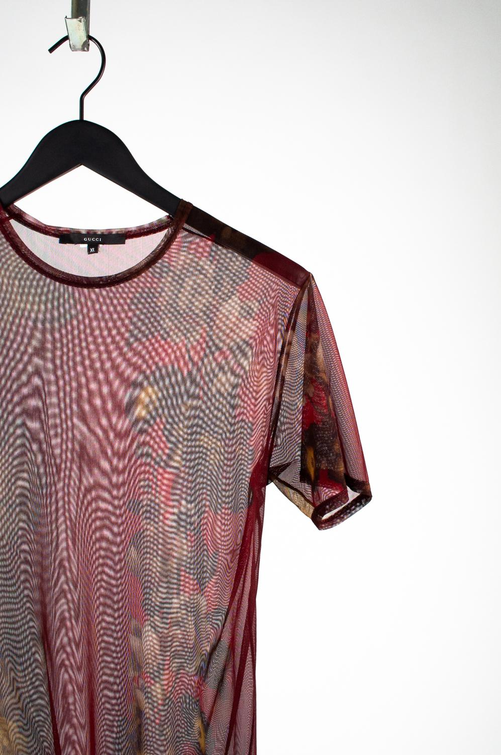 100% genuine Gucci Men by Tom Ford Floral Vintage T-Shirt 
Color: Burgundy
(An actual color may a bit vary due to individual computer screen interpretation)
Material: No tag seems nylon.
Tag size: XL  (slim but material is stretchy)
This t shirt is