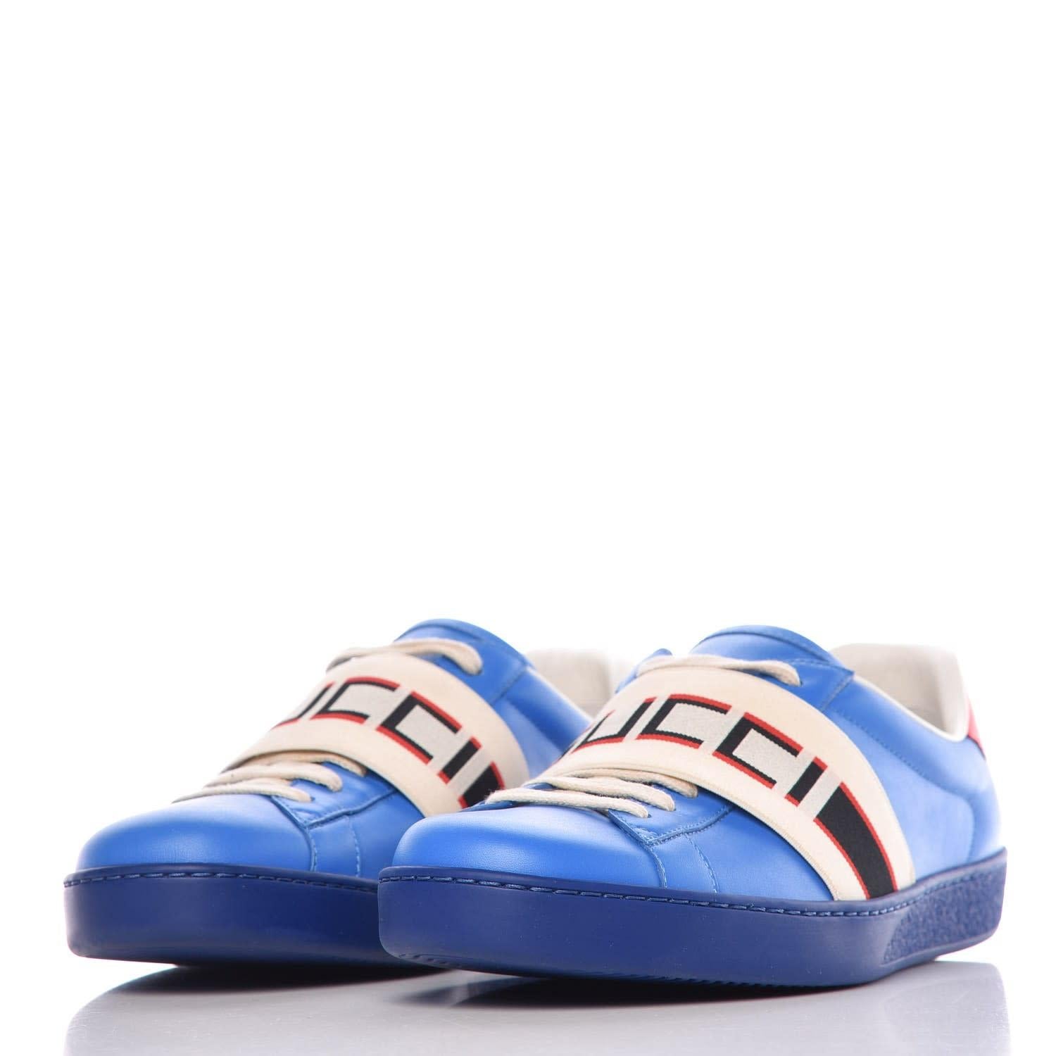 Calfskin Stripe Lace Up Sneakers 10 Blue Red. These Gucci sneakers are made of blue leather with a Gucci logo stripe over the laces and a red top line heel.

COLOR: Blue 
MATERIAL: Leather
ITEM CODE: 523469
SIZE: 43 EU / 10 US
EST. RETAIL: