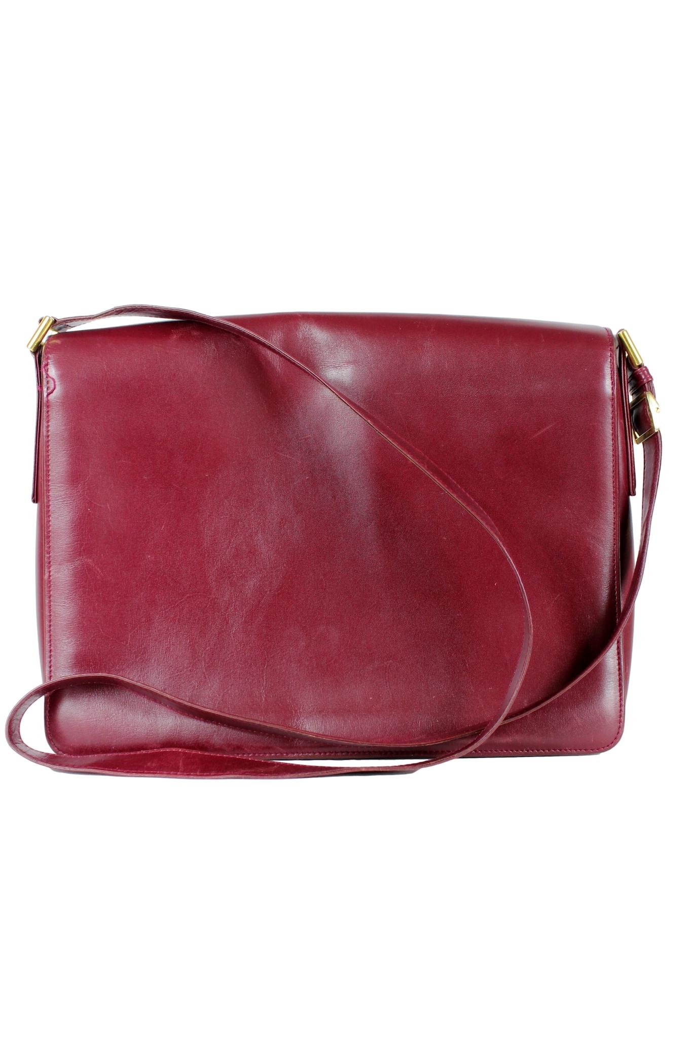 This stunning Gucci messenger bag is the perfect blend of vintage elegance and modern functionality. The burgundy color gives it a timeless look that will never go out of style. From the 1980s, this bag features a velvet lining and three inside