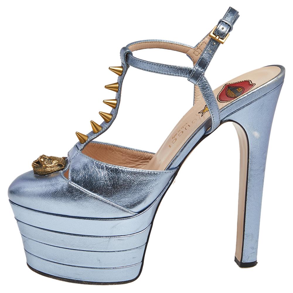 You're all set to touch the skies with these towering Angel sandals from Gucci. Shimmering in metallic blue, these sandals are crafted from leather and feature a chic silhouette. They flaunt round toes with cutouts and a tiger head and spikes on the