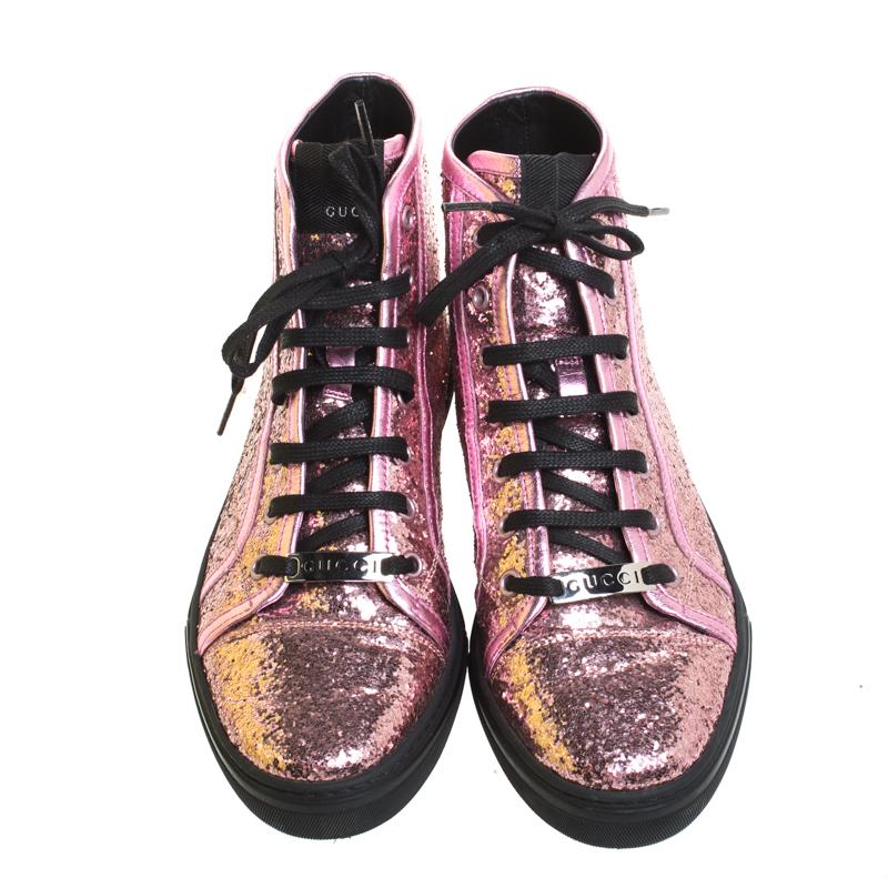 Add a bit of shine and distinct style to your regular sneakers with this beautiful pair of Gucci California high-top ones. Covered in metallic pink glitter, these sneakers feature leather trims, a lace-up front, round toes, rubber soles and leather