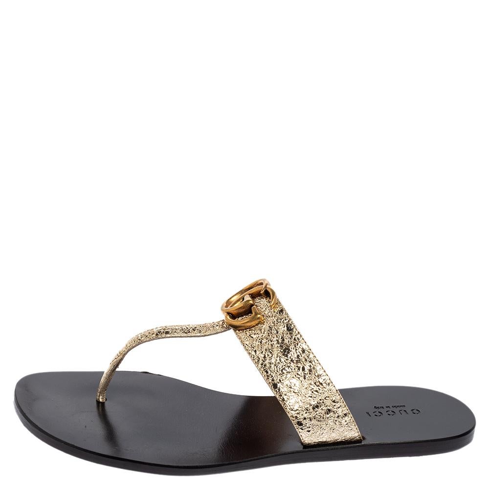 Step out summer-ready in this pair of thong sandals from Gucci. They've been crafted from metallic gold crinkled leather and styled with a gold-tone GG logo at the front. Flaunt them with dresses and shorts.

