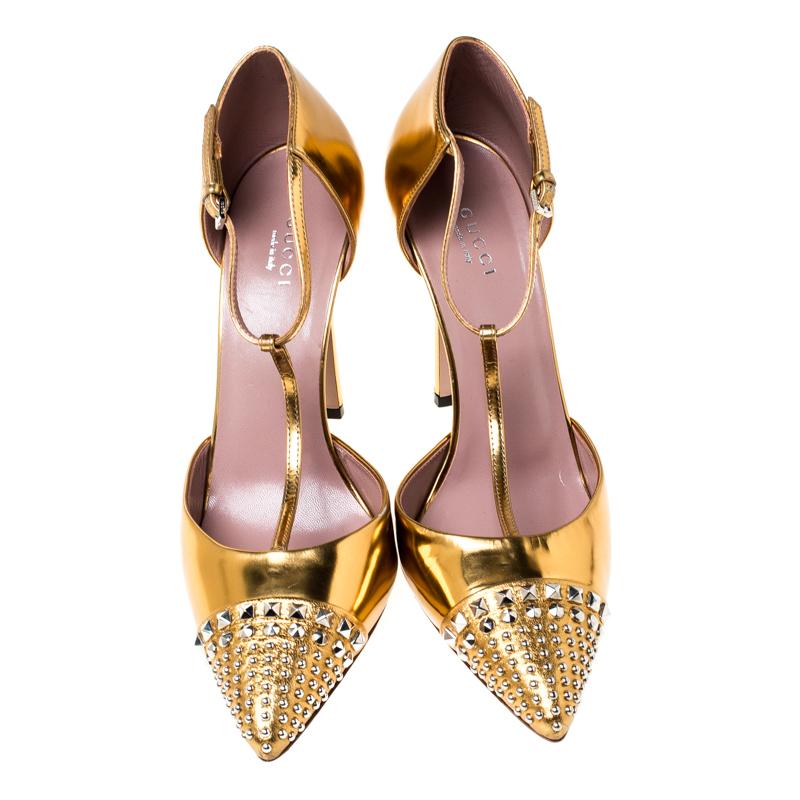 Perfect for channelling an air of elegance, these pumps from Gucci are worth investing in. The metallic gold pumps are crafted from foil leather and feature pointed-toes beautifully accented with studs. They flaunt a T-strap design with buckled