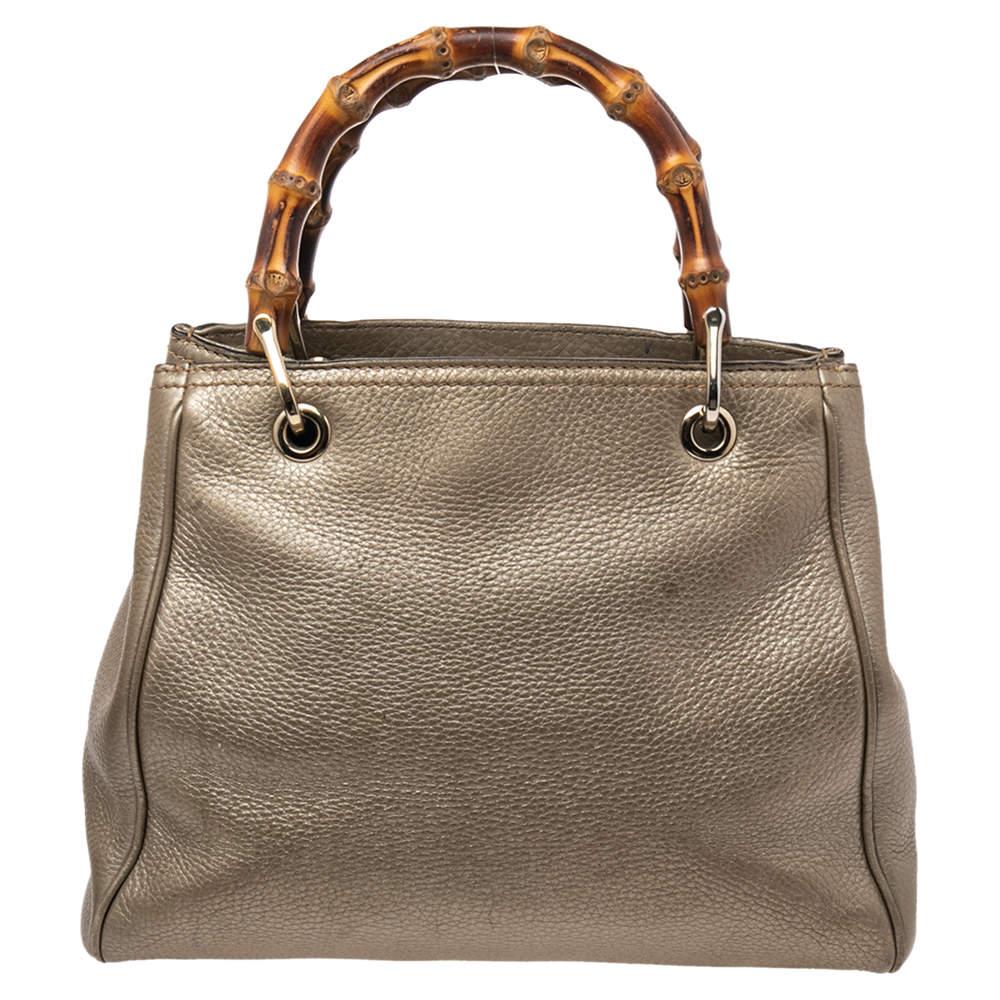 Handbags as fabulous as this one are hard to come by. So, own this gorgeous Gucci tote today and light up your closet! Crafted from metallic gold leather, this stunning number has a spacious canvas interior and is wonderfully held by two bamboo