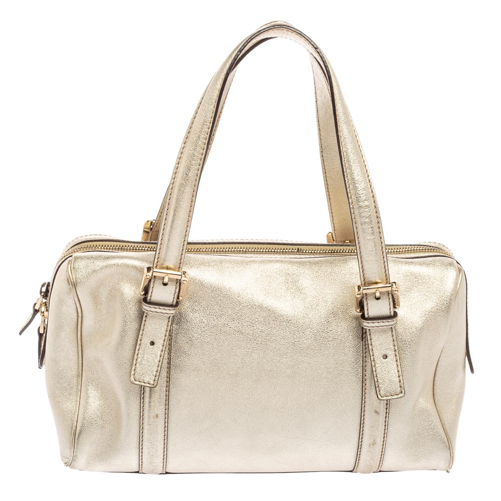Simple details, high quality, and everyday convenience mark this Britt Boston by Gucci. The bag is made of metallic gold leather and it features dual handles, a gold-tone GG logo on the front, and a spacious interior.

Includes: Original Dustbag,