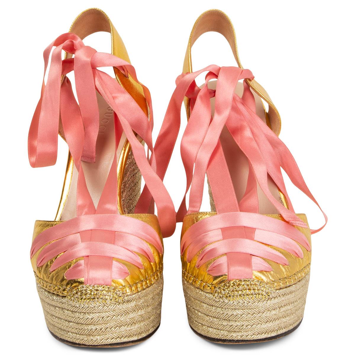 100% authentic Gucci Alexis wrap platform wedge sandals in metallic gold-tone leather and a raffia sole. Embellished with a baby pink ribbon tie. Have been worn and are in excellent condition. Come with dust bag. 

Measurements
Imprinted