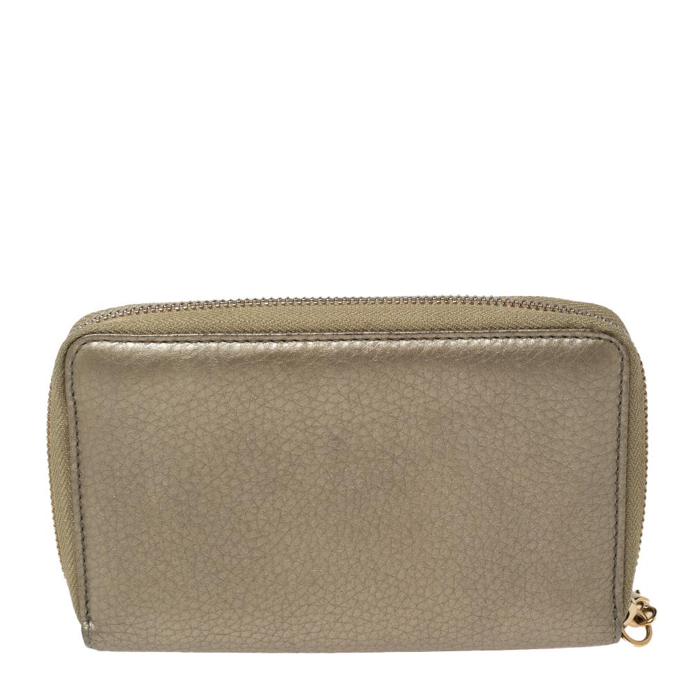 Gucci's expertise in crafting high-quality leather goods is evident through the creation of this piece. This wallet is designed using metallic-gold leather with an embossed GG motif highlighting the front. The zip-around feature of this wallet