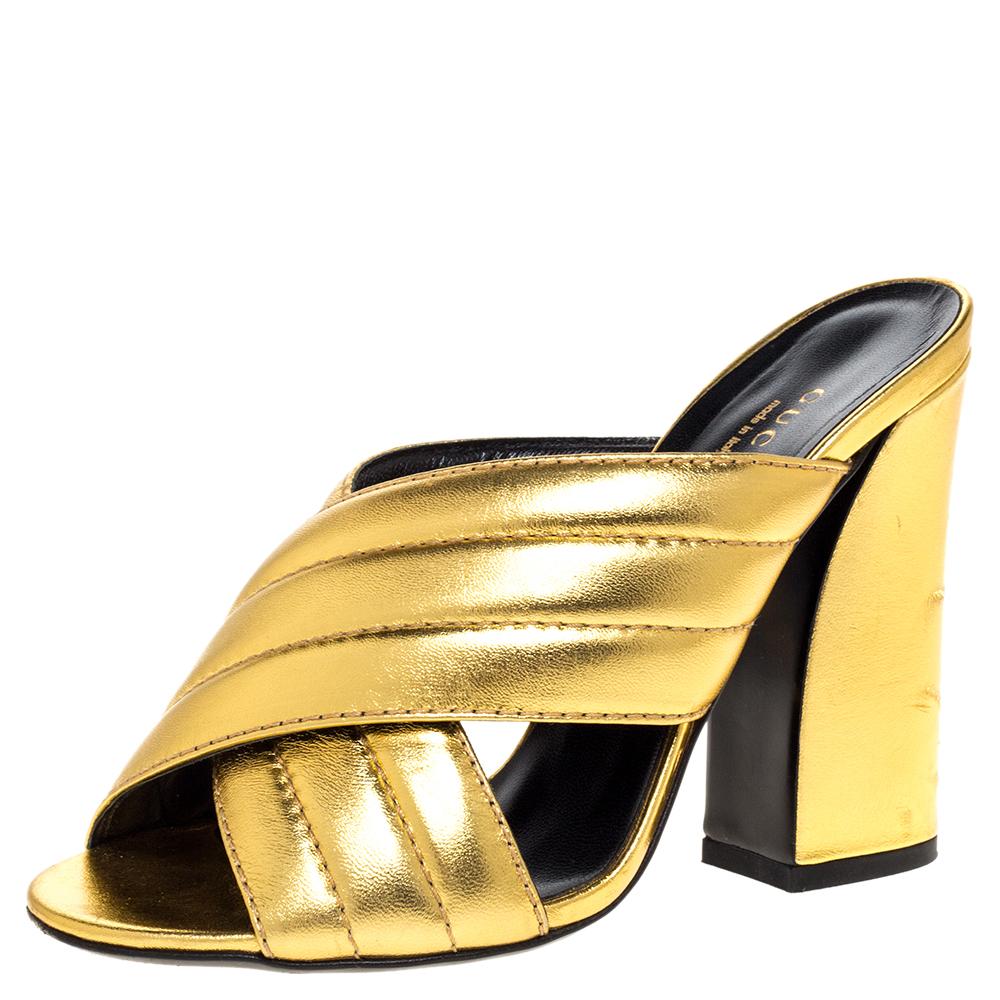 Epitomizing style and utmost comfort, these Sylvia sandals from Gucci are crafted from metallic gold leather and designed with cross-straps on the vamps. They make your feet happy with the leather-lined insoles and lift you up gracefully with 11 cm