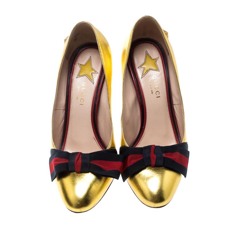 Super-comfortable and loaded with style, this pair of Gucci pumps will make your feet stand out. They've been crafted from gold leather, designed with block heels and their signature Web bows. The pair is sure to delight your dresses and