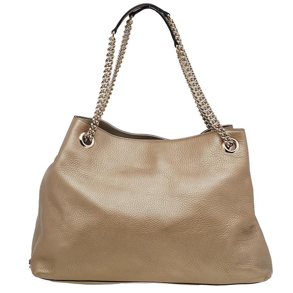 This metallic gold Soho tote is one of the many designs by Gucci that is loved by women worldwide. The bag is constructed from pebbled leather and designed with the signature GG on the front. It features a spacious canvas interior for your