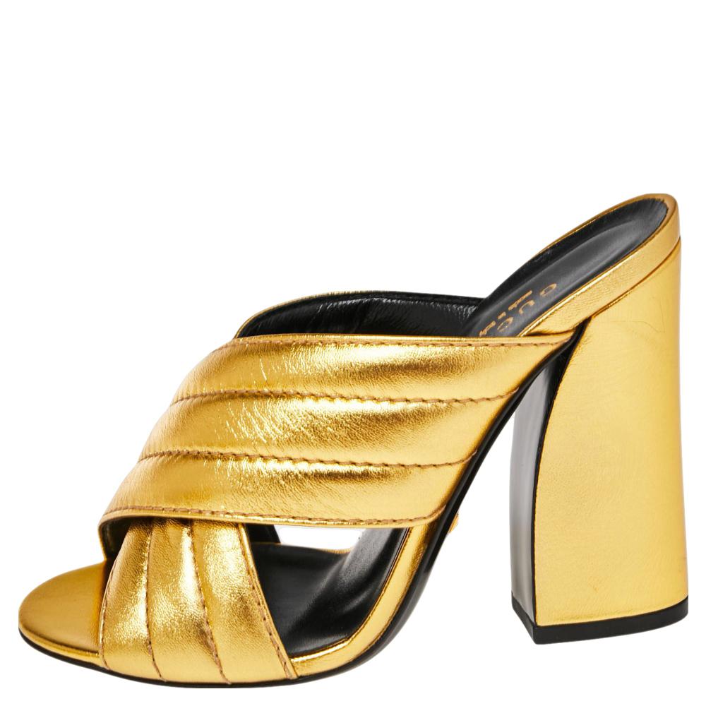 Join the mule trend today with these from Gucci. Crafted from leather in a metallic gold shade, they have been styled with two, quilted crossover straps at the vamp and block heels. The insoles have also been lined with leather and stamped with the
