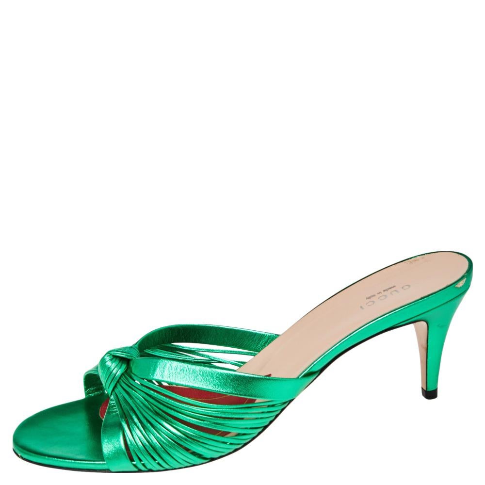 Flaunt your love for exquisite fashion as you wear these slide sandals from Gucci. These sandals are crafted using metallic green leather on the exterior with a knotted detail on the front. Unique and fancy in their appearance, these sandals are
