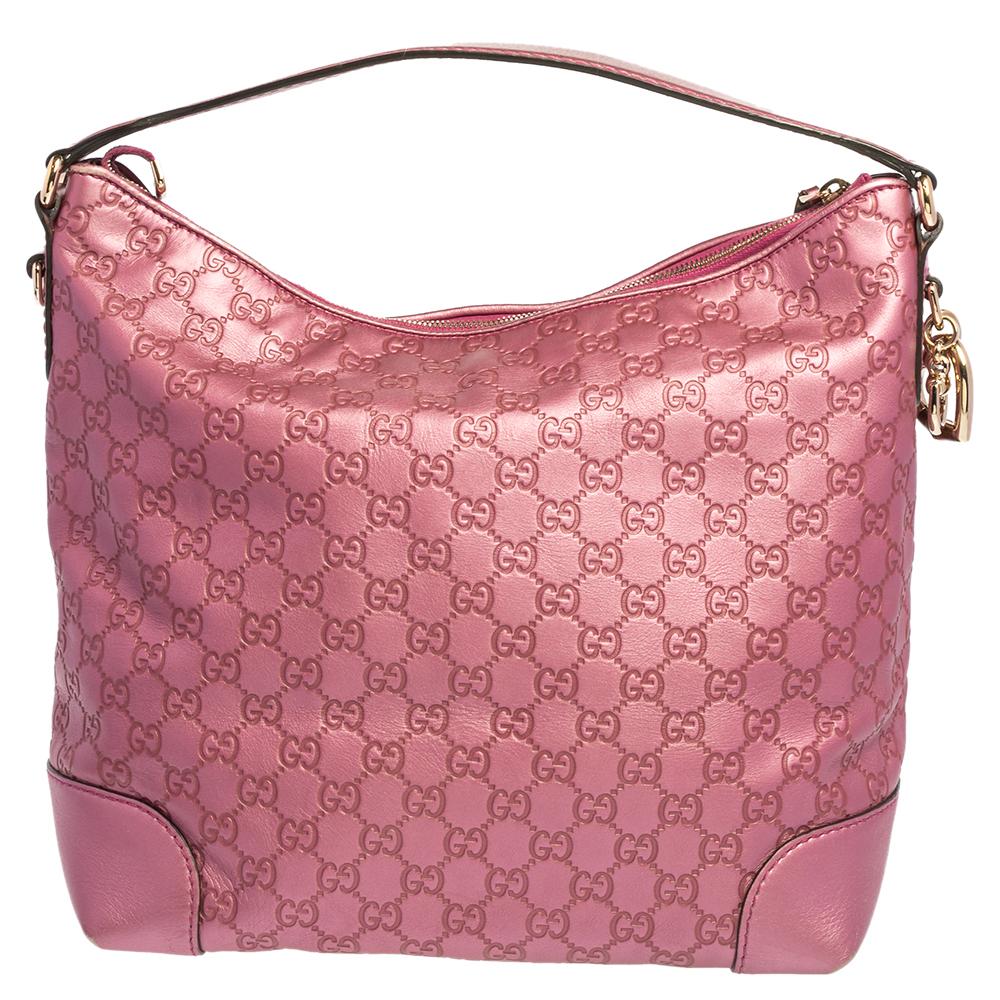 Glam up your daytime look with this medium metallic hobo by Gucci. Crafted from quality Guccissima leather, the handbag is accented with a heart charm, a comfortable single handle, and gold-tone hardware. Its spacious interior is lined with canvas