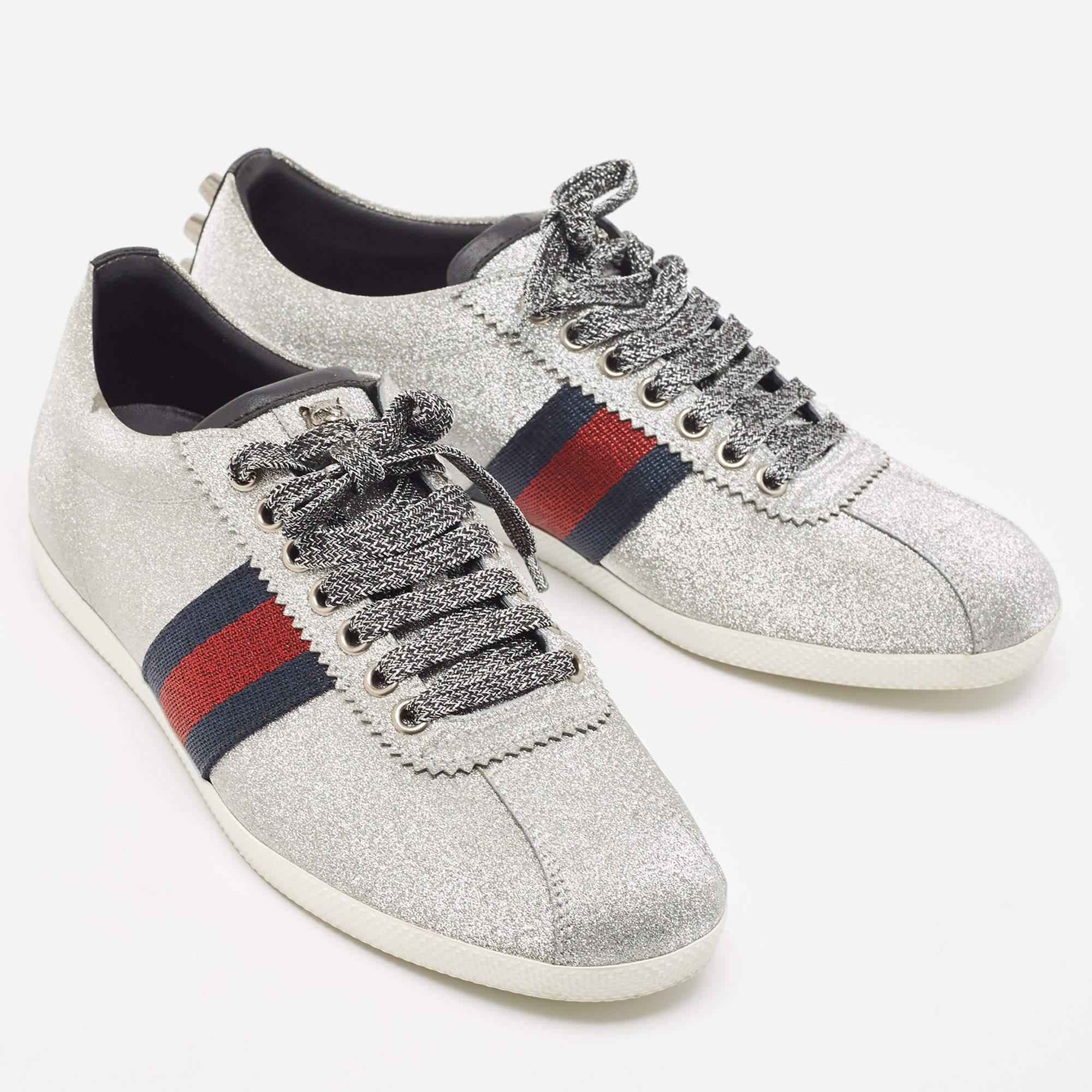 Presented in a classic silhouette, these Gucci silver sneakers are a seamless combination of luxury, comfort, and style. These sneakers are designed with signature details and comfortable insoles.

