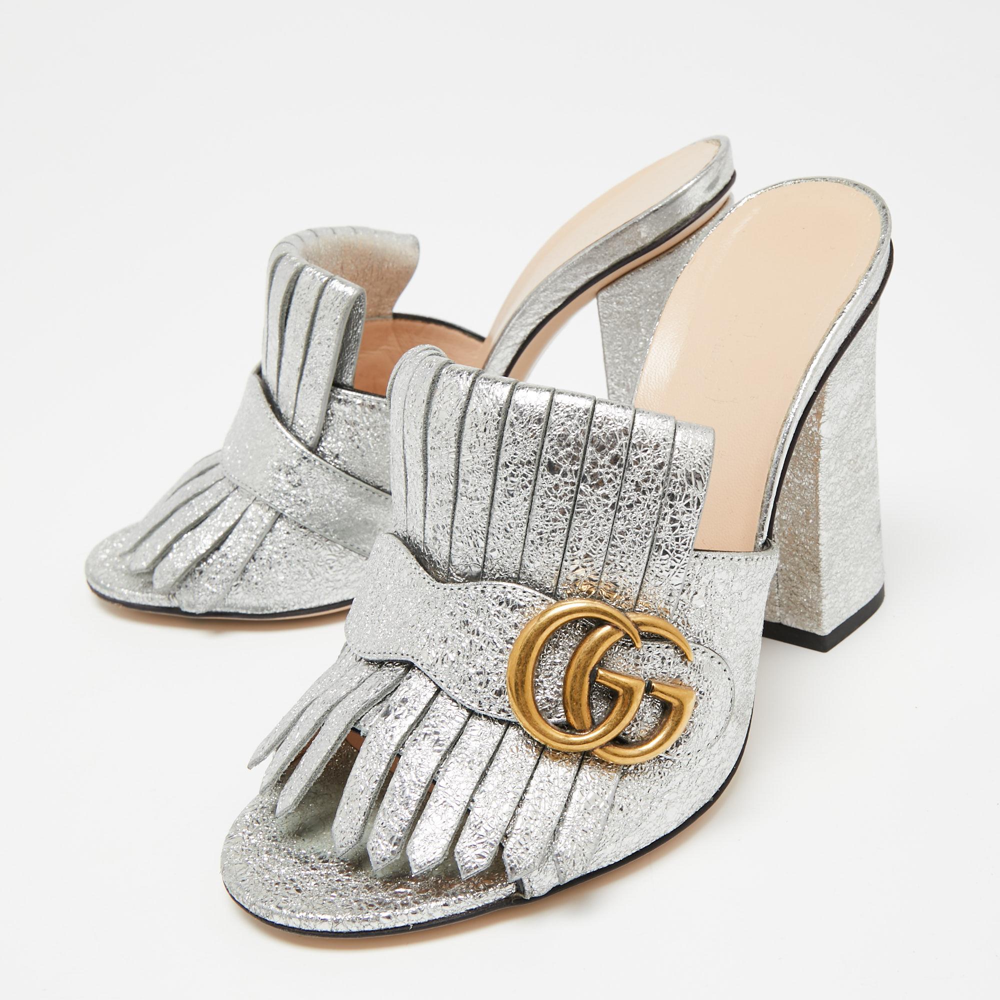 This pair of sandals by Gucci is a buy to wear and treasure. The shoes have been crafted from leather and styled with folded fringes and the brand's signature GG on the uppers. Square toes and a set of block heels complete them.

