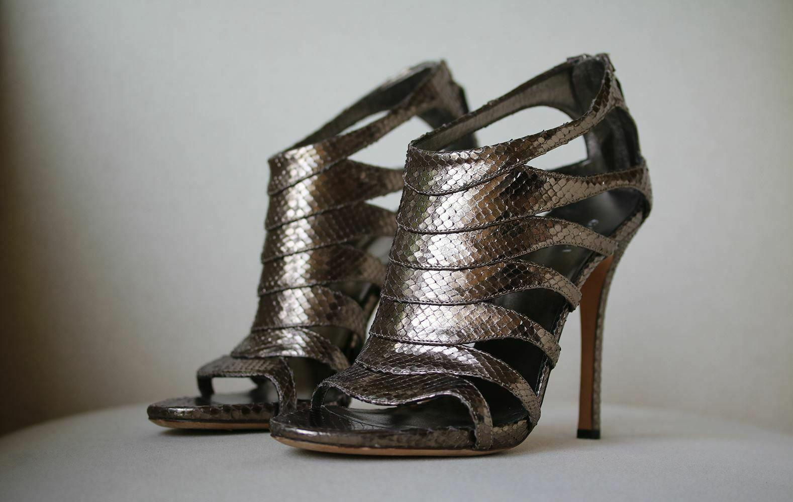 Gucci cutout snakeskin leather sandals. Zip fastening down the back. Leather insole and sole. Metallic gunmetal silver.

Size: EU 38.5 (UK 5.5, US 8.5)

Condition: Worn once. Slightest wear to the soles; see pictures. Otherwise, no sign of wear.