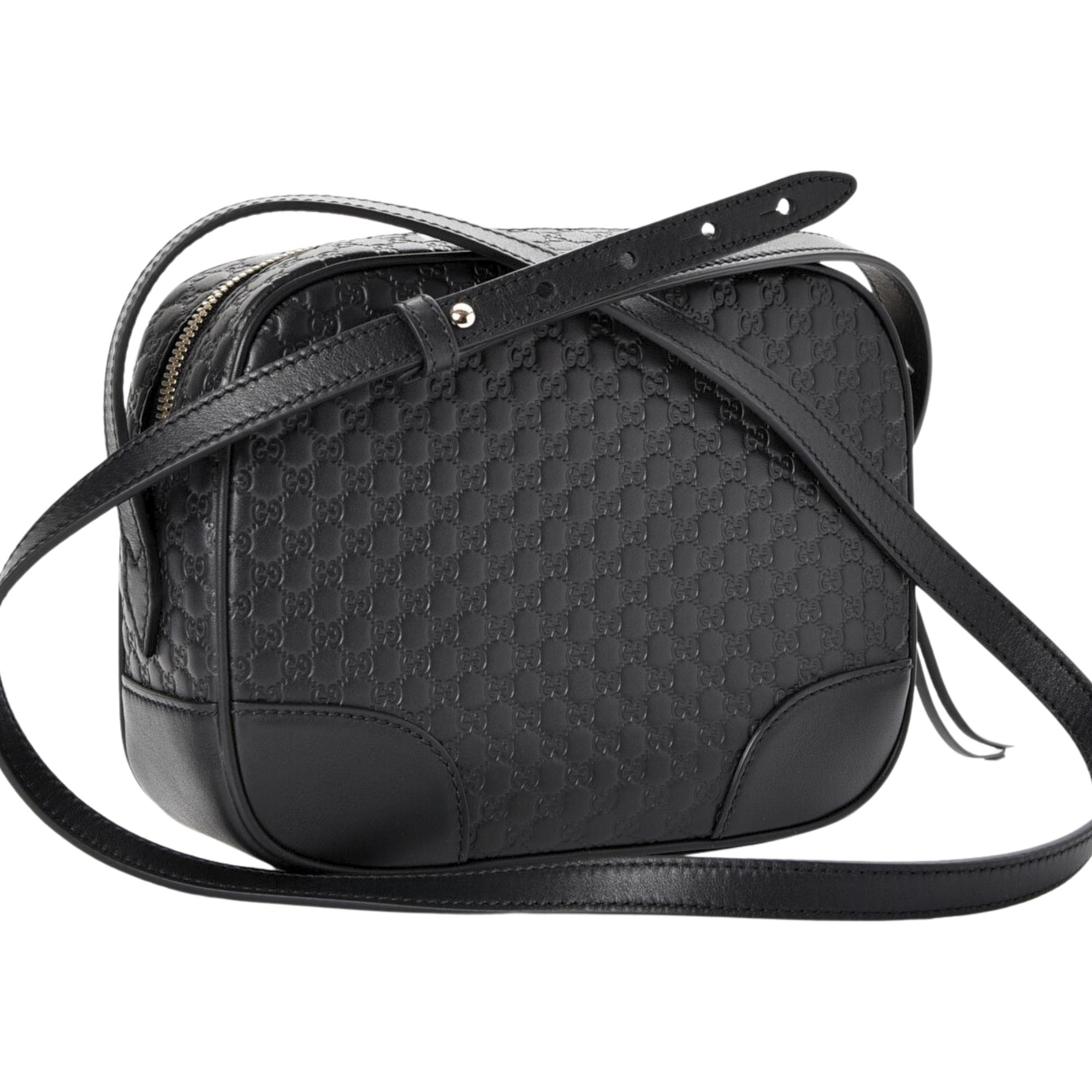 This Gucci bag is made with embossed calfskin leather in black. The bag features Gucci’s iconic microguccisima embossed leather, light-gold hardware, an adjustable shoulder strap and top zip closure. The doubler zipper tabs open to a beige canvas