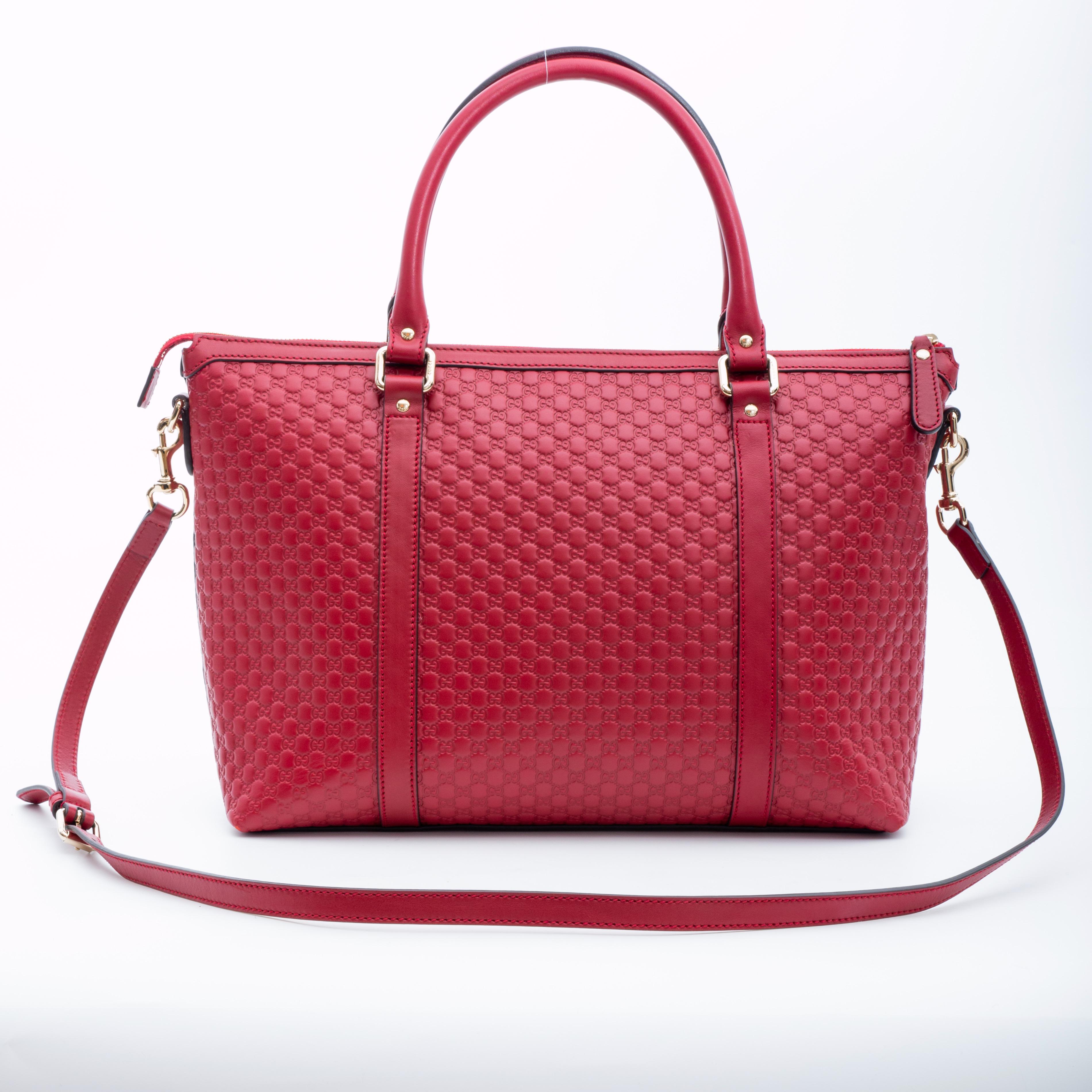 This tote is made of embossed microguccissima leather in red. The bag features dual rolled leather top handles, an optional shoulder strap, light gold hardware, top zip closure and a beige fabric interior with a patch pocket.

COLOR: Red
MATERIAL: