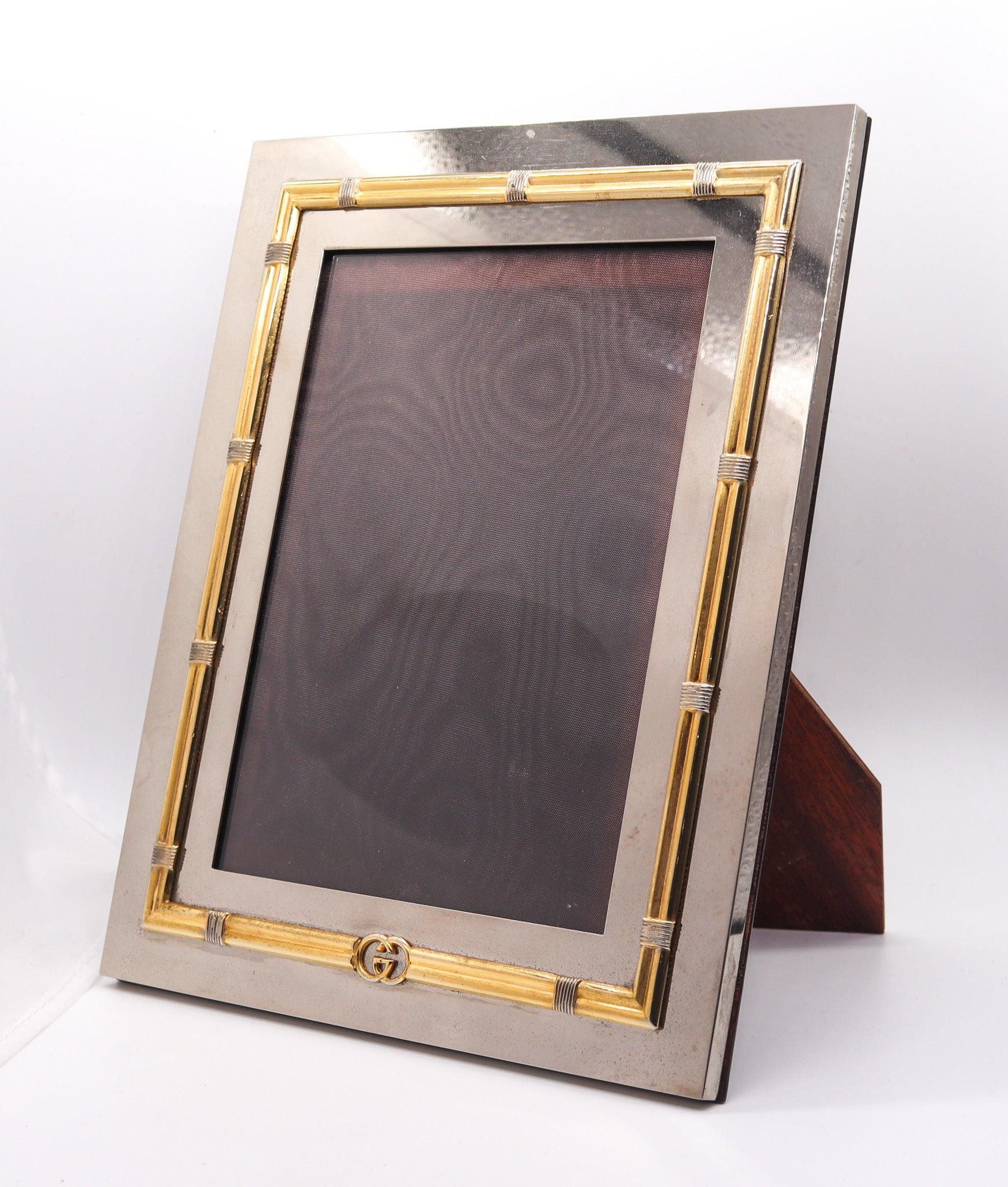 Desk picture frame designed by Gucci.

This is a very decorative desk picture frame, created in Milano Italy by the fashion house of Gucci, back in the 1970. The frame is very elusive and flamboyant, and was crafted with parts in chrome, gilt