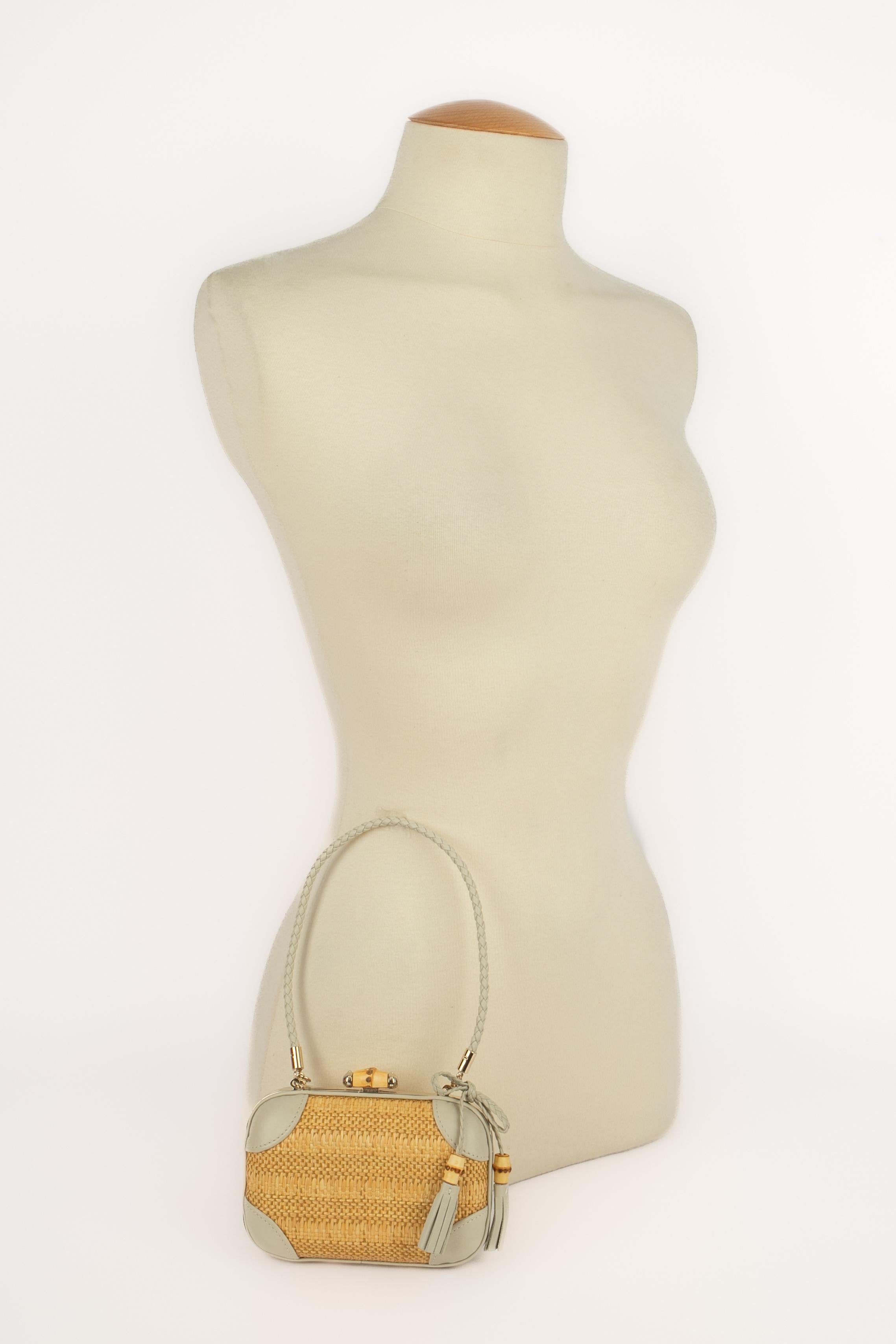 Gucci - (Made in Italy) Borsa minaudiere in pelle e rafia con chiusura in bambù ed elementi in metallo color champagne.

Condizioni:
Ottime condizioni

Dimensioni:
Lunghezza: 15 cm - Altezza: 10 cm - Profondità: 5 cm - Manico: 42 cm

SKU:S171