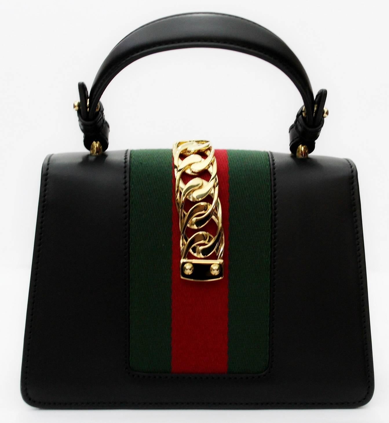 
From the current collection of Gucci this is the beautiful Sylvie mini. 
Gold hardware.
Nylon web in red and green
Leather shoulder strap
