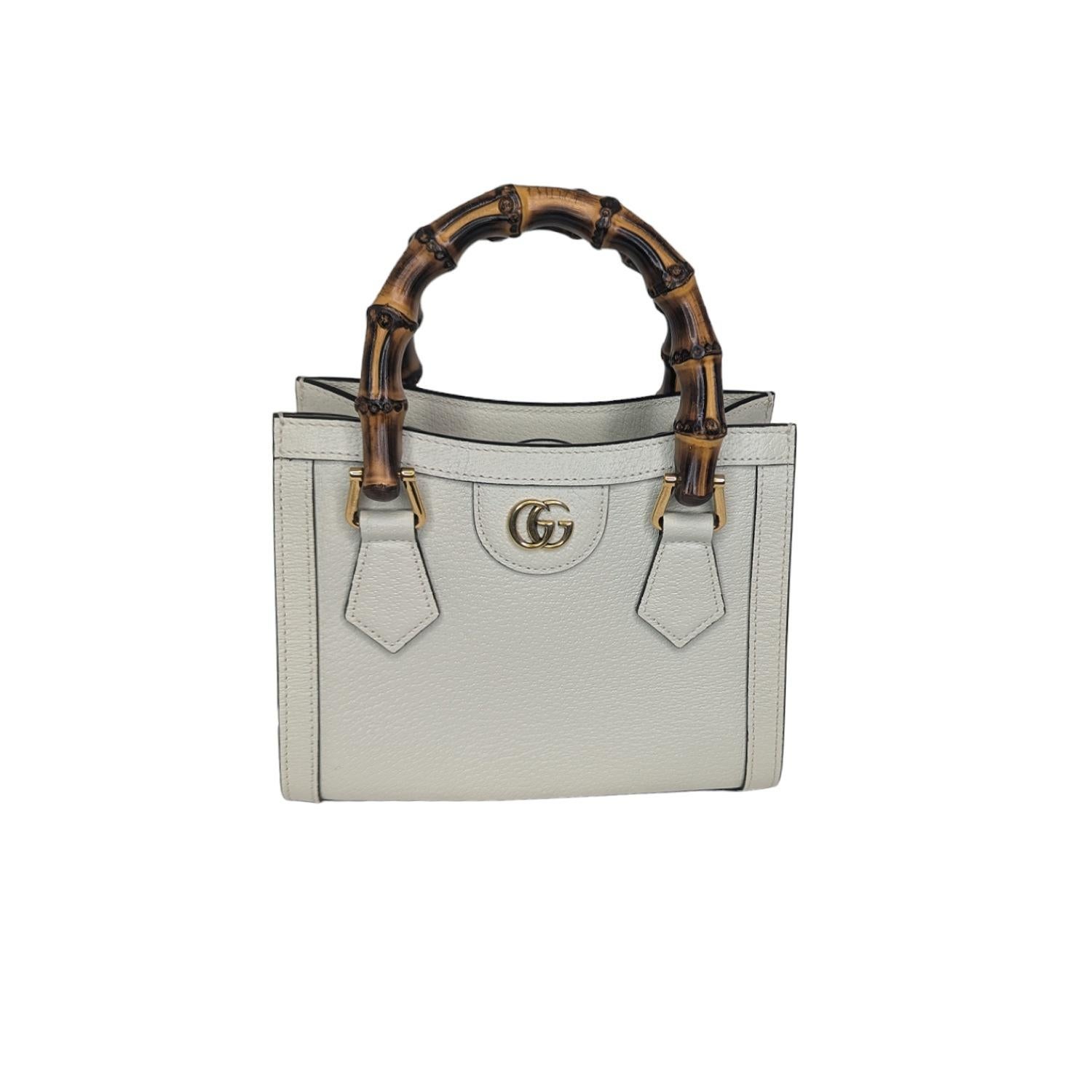Crafted from luxurious white leather, the bag exudes elegance and sophistication. Signature bamboo handles with a 3-inch drop offer a comfortable carrying experience. A detachable and adjustable leather shoulder strap provides versatility for
