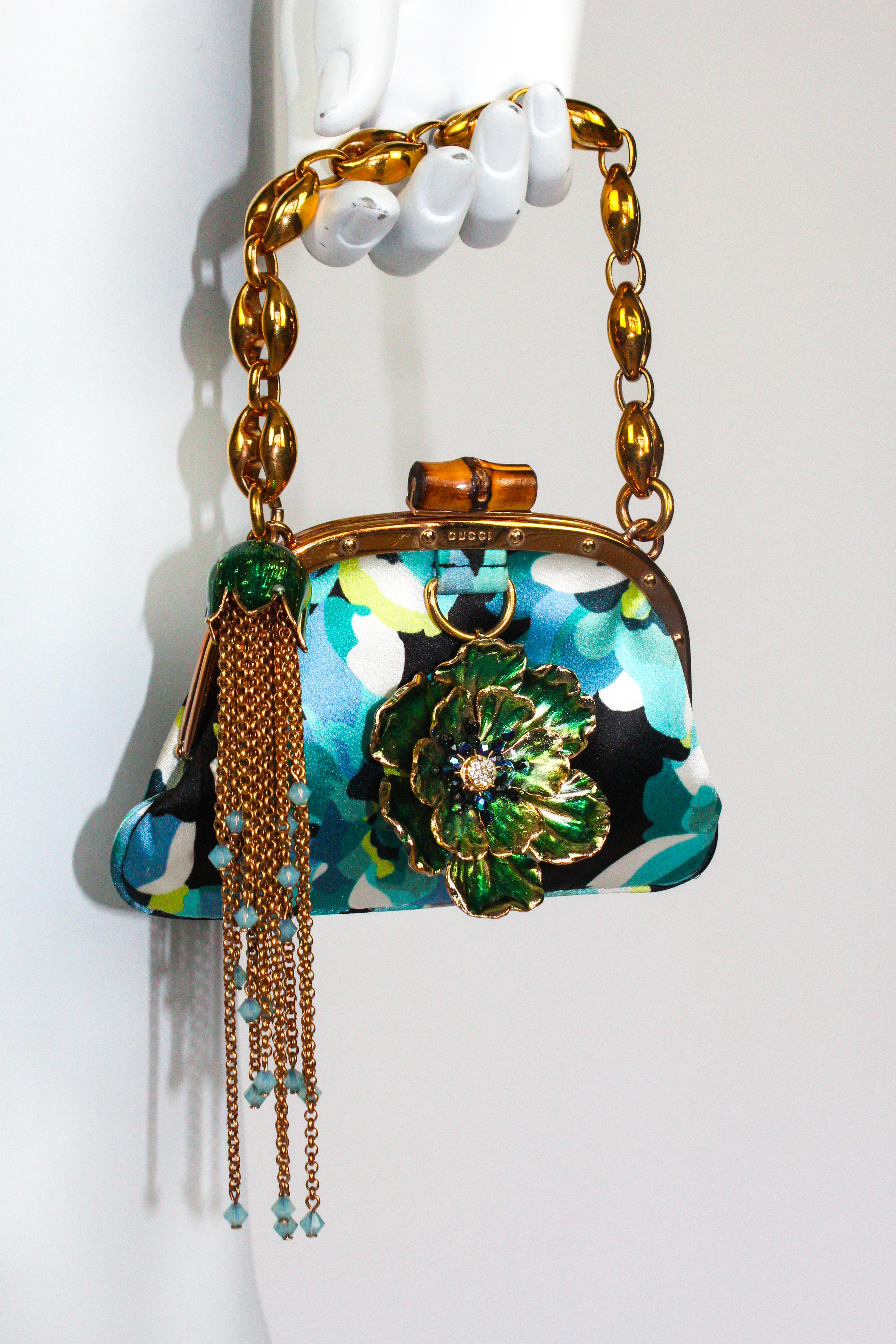 Gucci Spring/Summer 2006 embellished mini bag, as seen on the runway and advertising campaign. Incredible and rare collector's piece, featuring a blue floral silk design, with beaded chain tassel and floral charm to the front. Bamboo kisslock