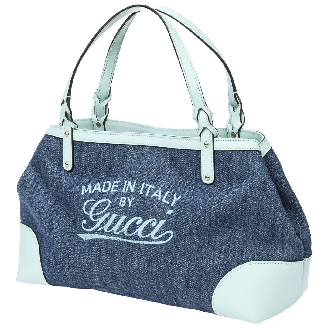 A refreshing mint blue denim canvas tote adorned with gold hardware and a zipper closure. The canvas interior is practical with one zippered pocket and two slip pockets.

SPECIFICS
Length: 14.2
Width: 6
Height: 8.7
Strap drop: 6.5
Authenticity code: