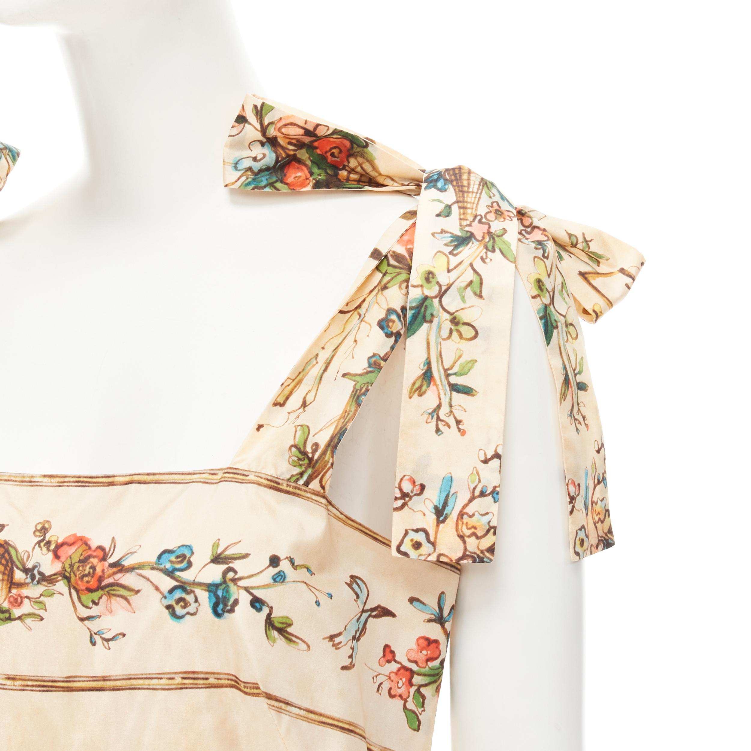 GUCCI Modern Future calligraphy floral print bow tie strap flared dress IT42 M 
Reference: AEMA/A00051 
Brand: Gucci 
Designer: Alessandro Michele 
Collection: Modern Future Material: Silk 
Color: Beige 
Pattern: Floral 
Closure: Zip 
Extra Detail: