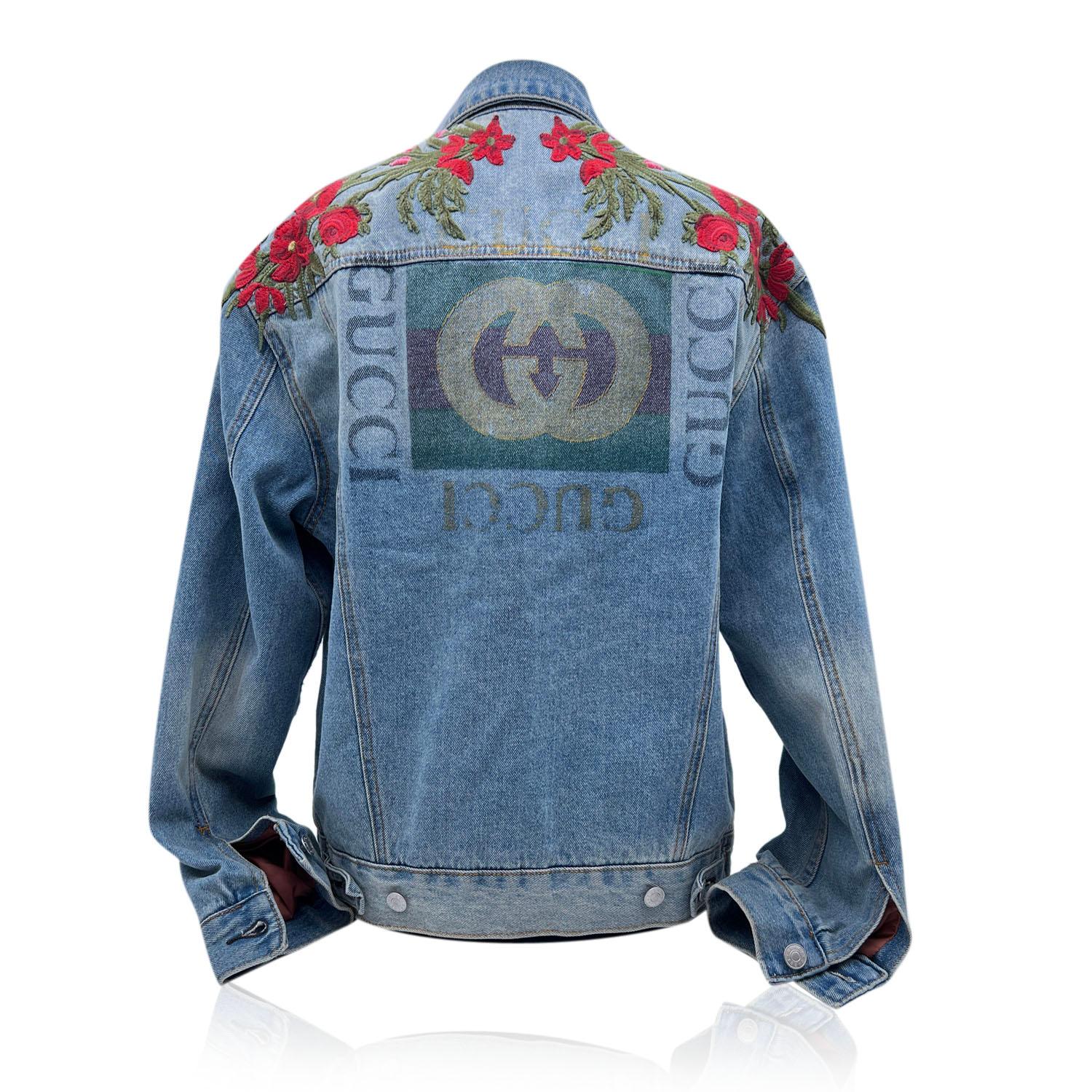 Gucci 'Modern' Denim Jeans from Gucci: light blue cotton denim jacket featuring 'Modern' writing on the front, embroidered red flowers on the shoulders and GG logo printed on the back. 2 side pockets on the waist and two chest pockets. Composition: