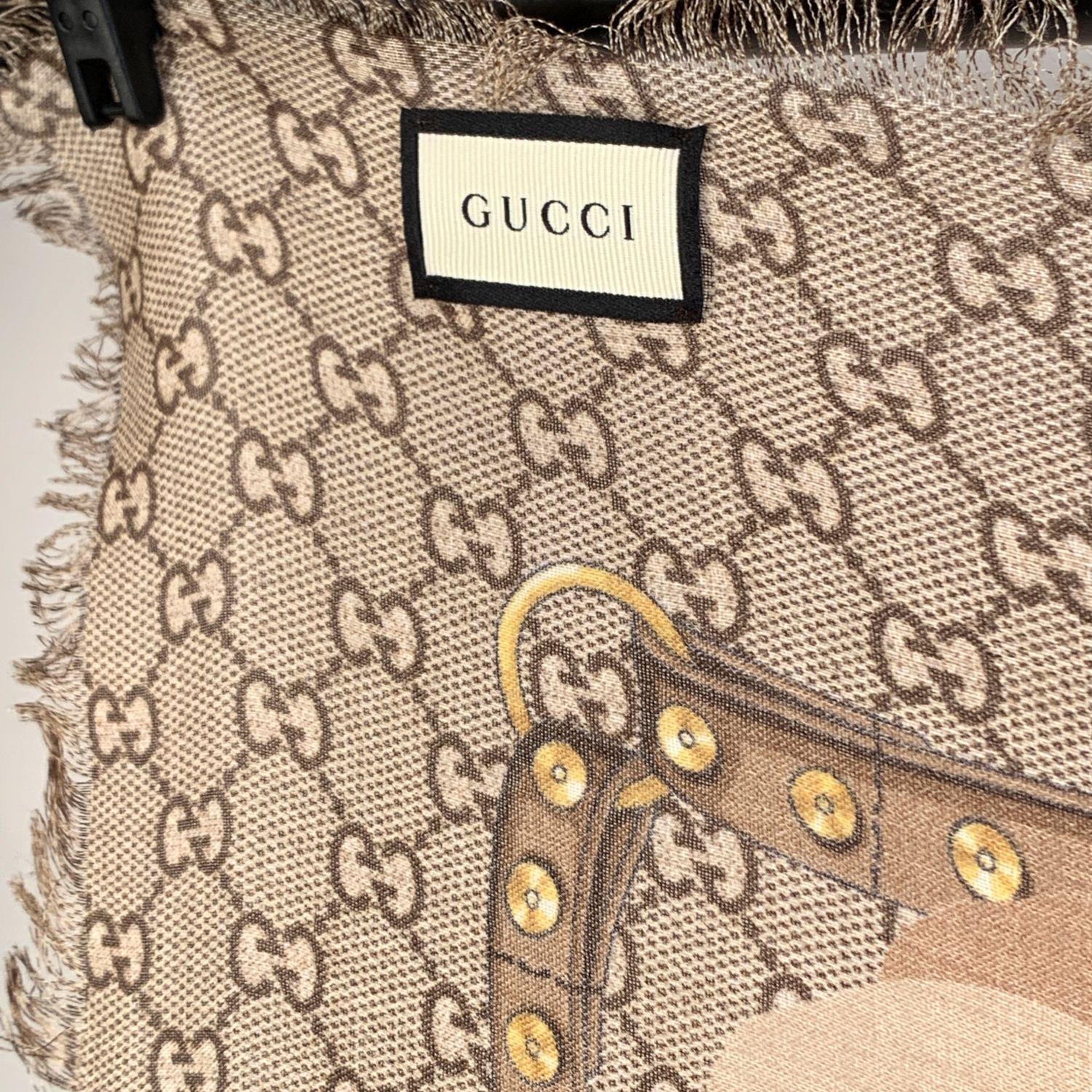 GUCCI large monogram shawl with beige GG monogram pattern with red Oshibana flowers horsebits, chains and belts printed all around the shawl. Frayed borders. 100% wool. GUCCI signature printed in a corner. Composition and care tags attached,