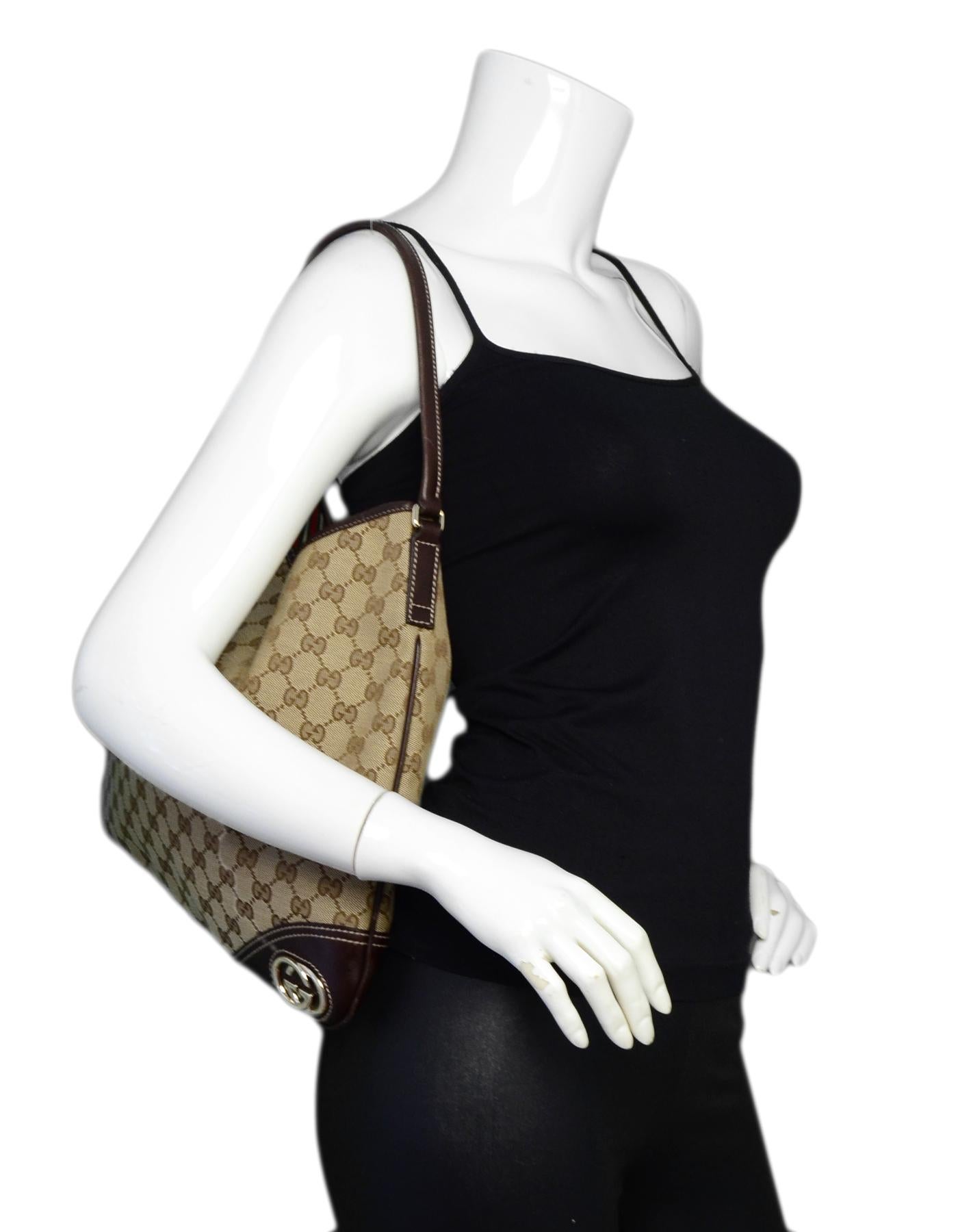Gucci Monogram Canvas Britt Hobo Bag w/ Leather Trim

Made In: Italy
Color: Beige
Hardware: Silvertone hardware
Materials: Coated canvas, leather trim
Lining: Striped textile lining
Closure/Opening: Magnetic snap
Exterior Pockets: N/A
Interior