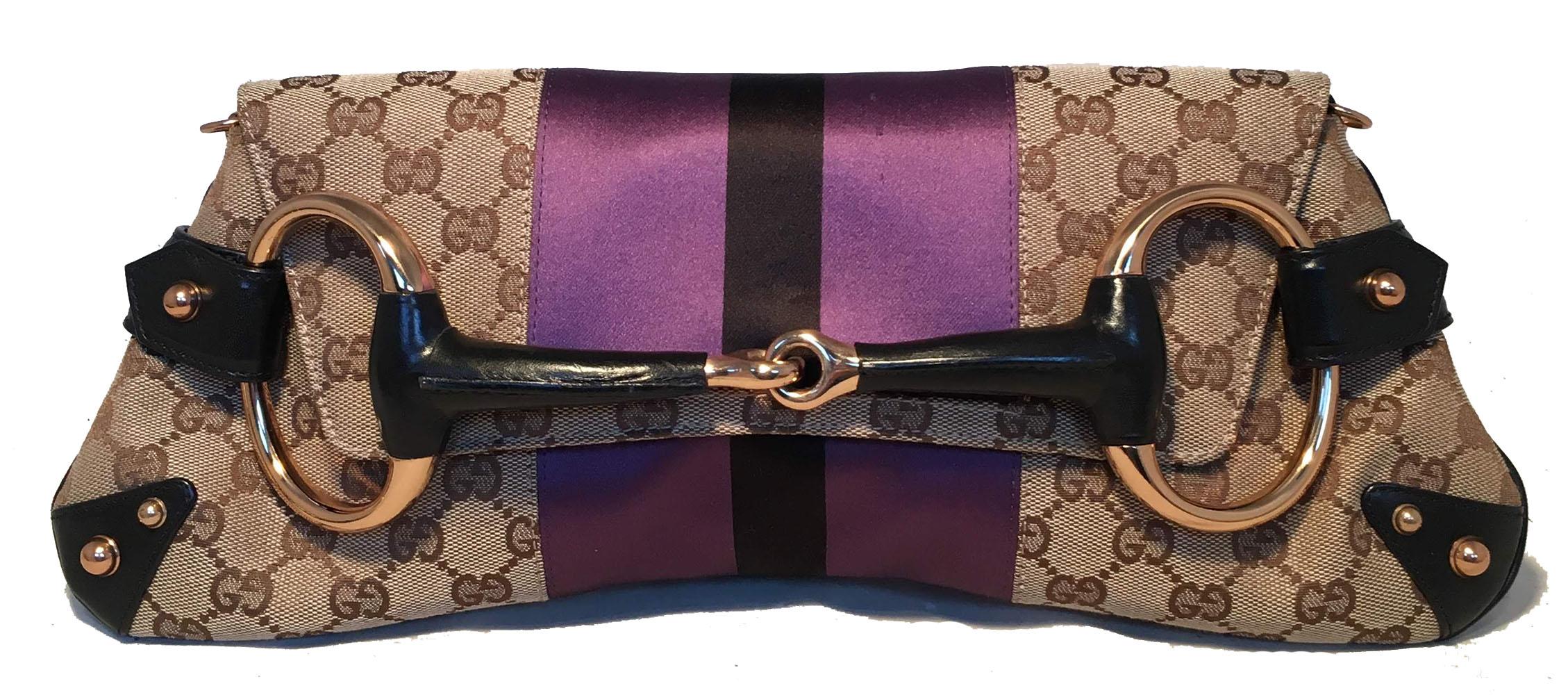 Gucci Monogram Canvas Satin Stripe Harness Horsebit Chain Clutch in excellent condition. Signature monogram canvas exterior trimmed with centered purple and black satin stripes, black leather, and gold hardware. Lifting flap snap closure opens to a